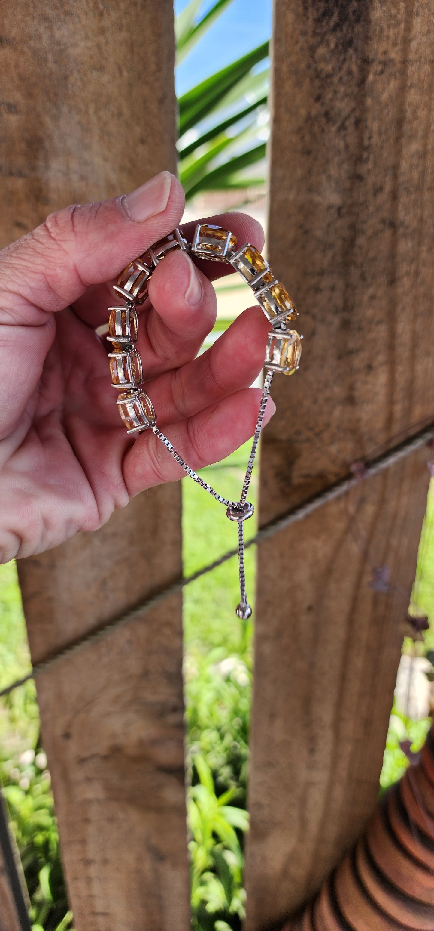 This gorgeous and STATEMENT Tennis style bracelet is crafted in Sterling Silver and features 9x large sized Oval Faceted Cut Yellow Citrine Gemstones.