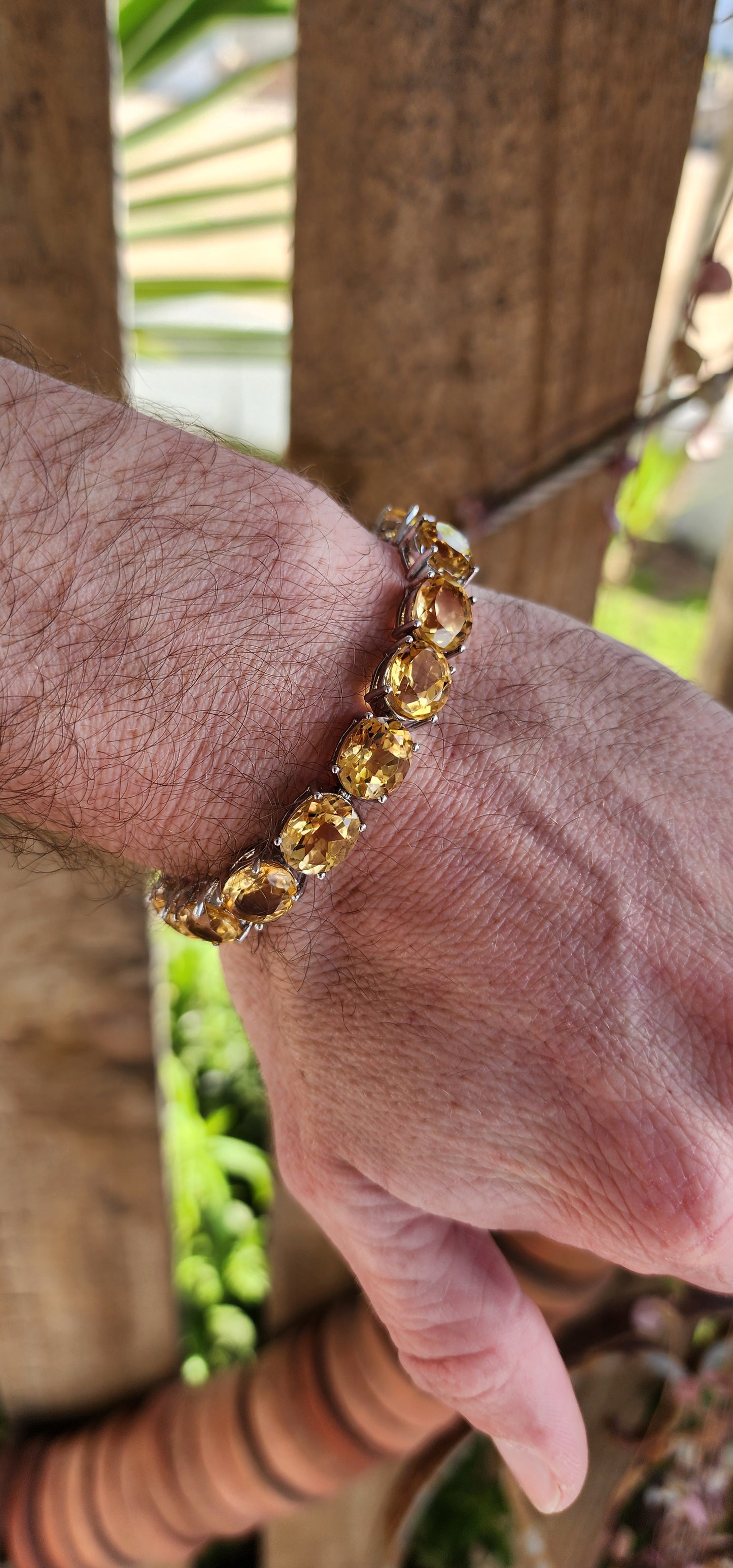 This gorgeous and STATEMENT Tennis style bracelet is crafted in Sterling Silver and features 9x large sized Oval Faceted Cut Yellow Citrine Gemstones.