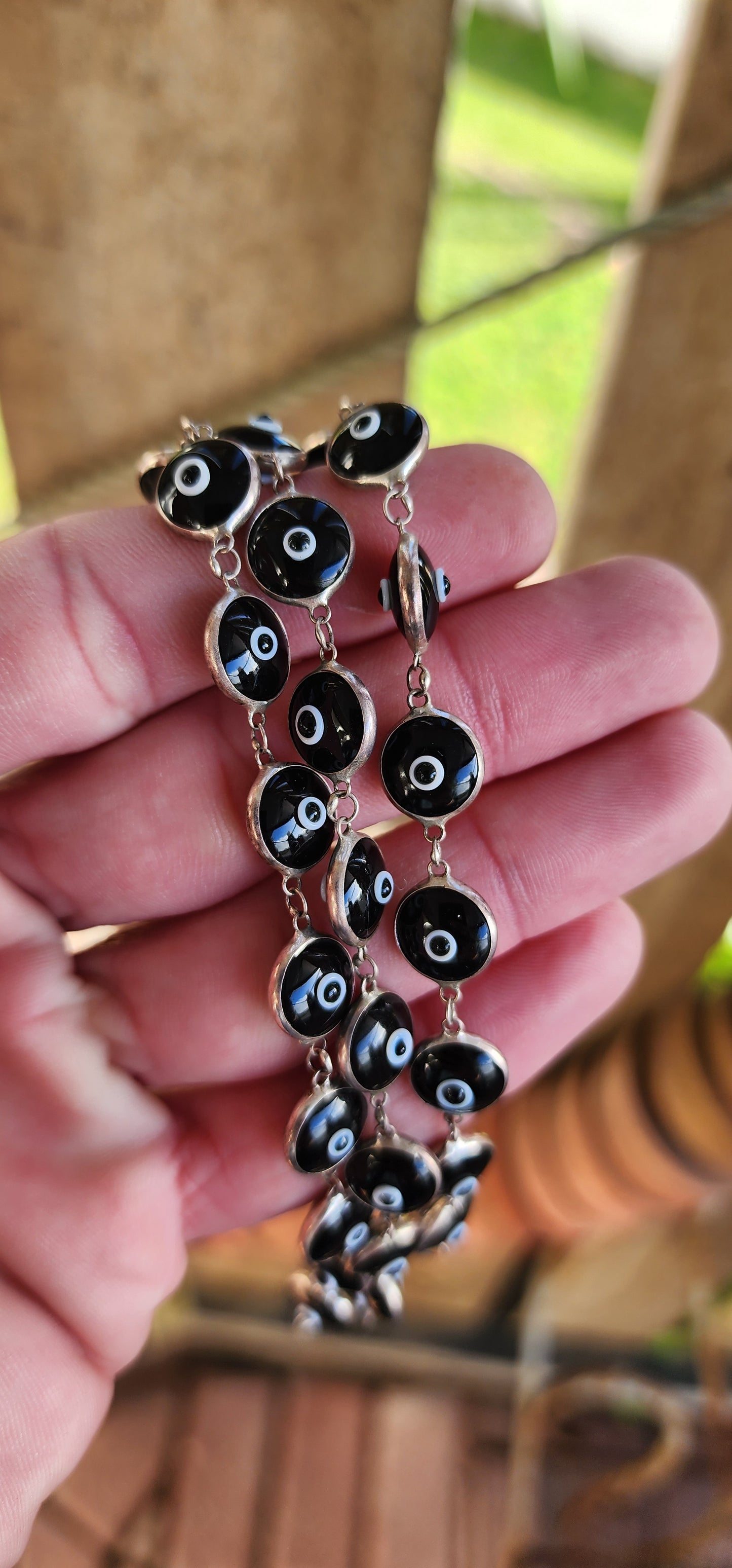 Sterling Silver bracelets featuring double sided Black and White Glass Evil Eye links.
