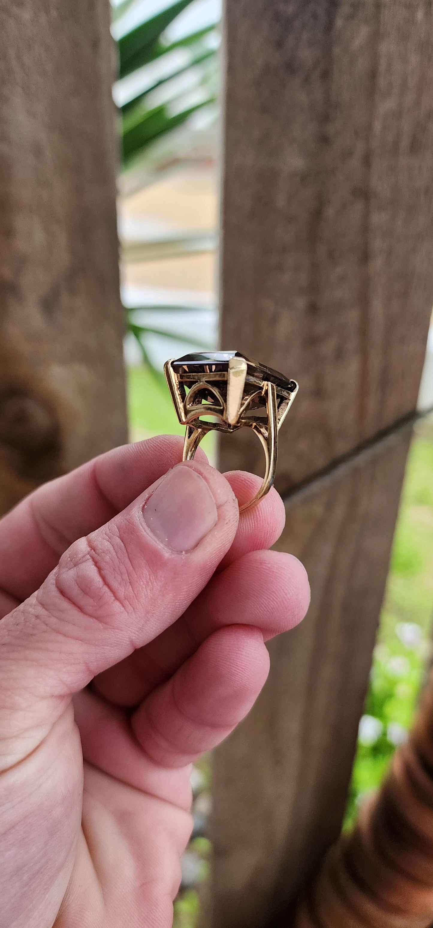 Marvelous Vintage Designer 1950s statement Cocktail/Dress ring featuring a super large Emerald cut Smokey Quartz Gemstone claw-set in a ornate 9ct Yellow Gold Art Deco basket setting. The ring is an STATEMENT piece!!