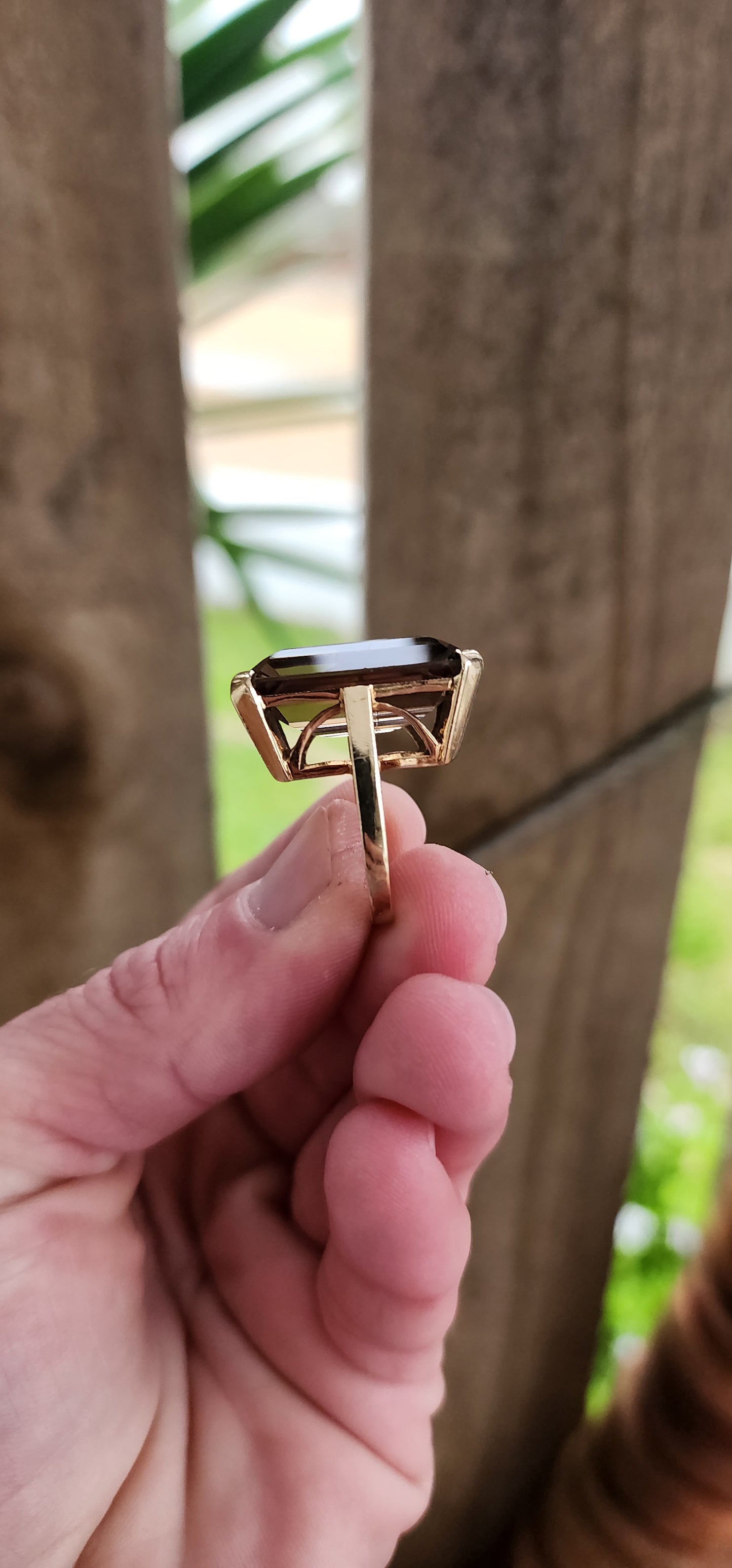 Marvelous Vintage Designer 1950s statement Cocktail/Dress ring featuring a super large Emerald cut Smokey Quartz Gemstone claw-set in a ornate 9ct Yellow Gold Art Deco basket setting. The ring is an STATEMENT piece!!