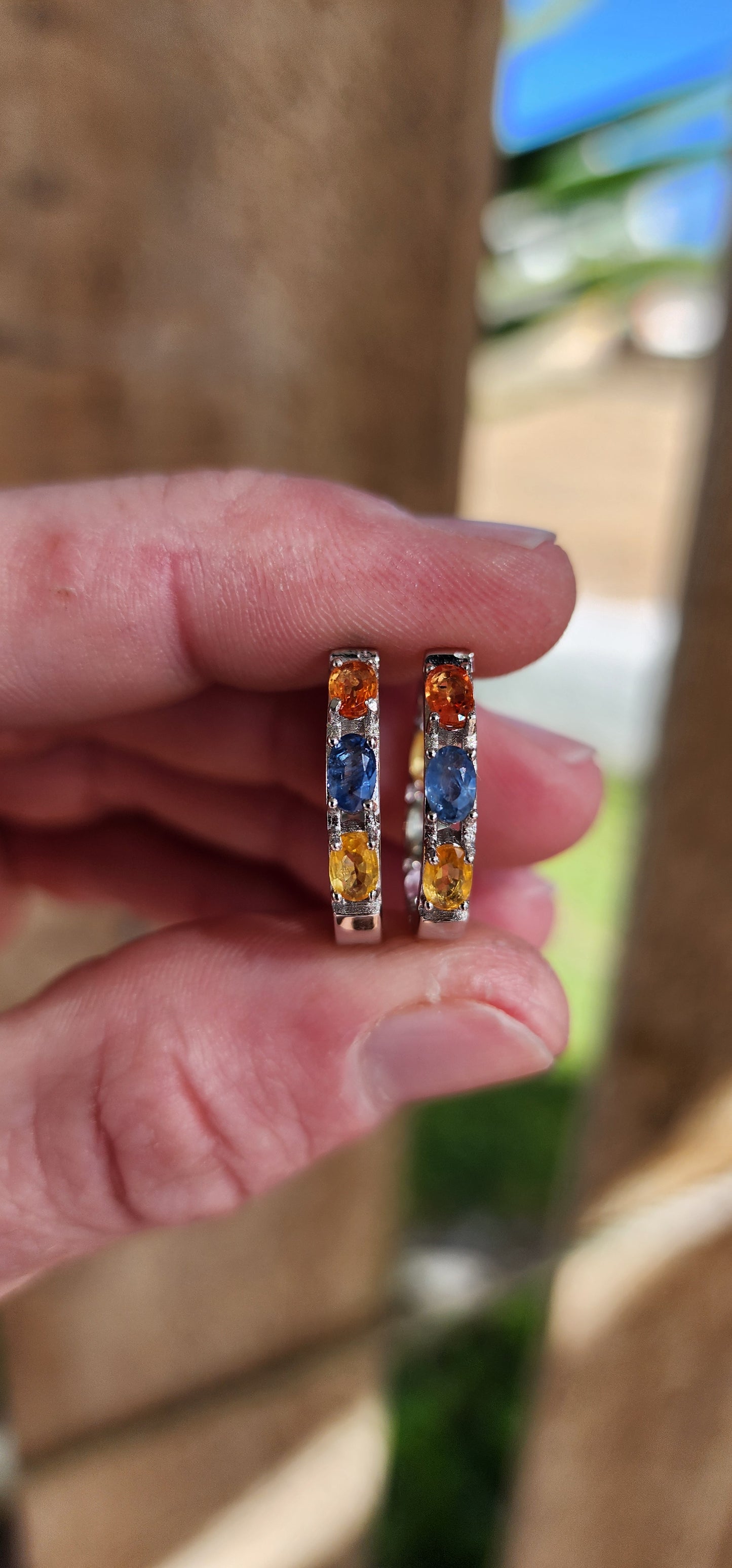 Gorgeous pair of Sterling Silver and multicolor Sapphire Gemstones Huggies/Hoop earrings .Each earring set with 6x Oval Faceted Cut Sapphires.