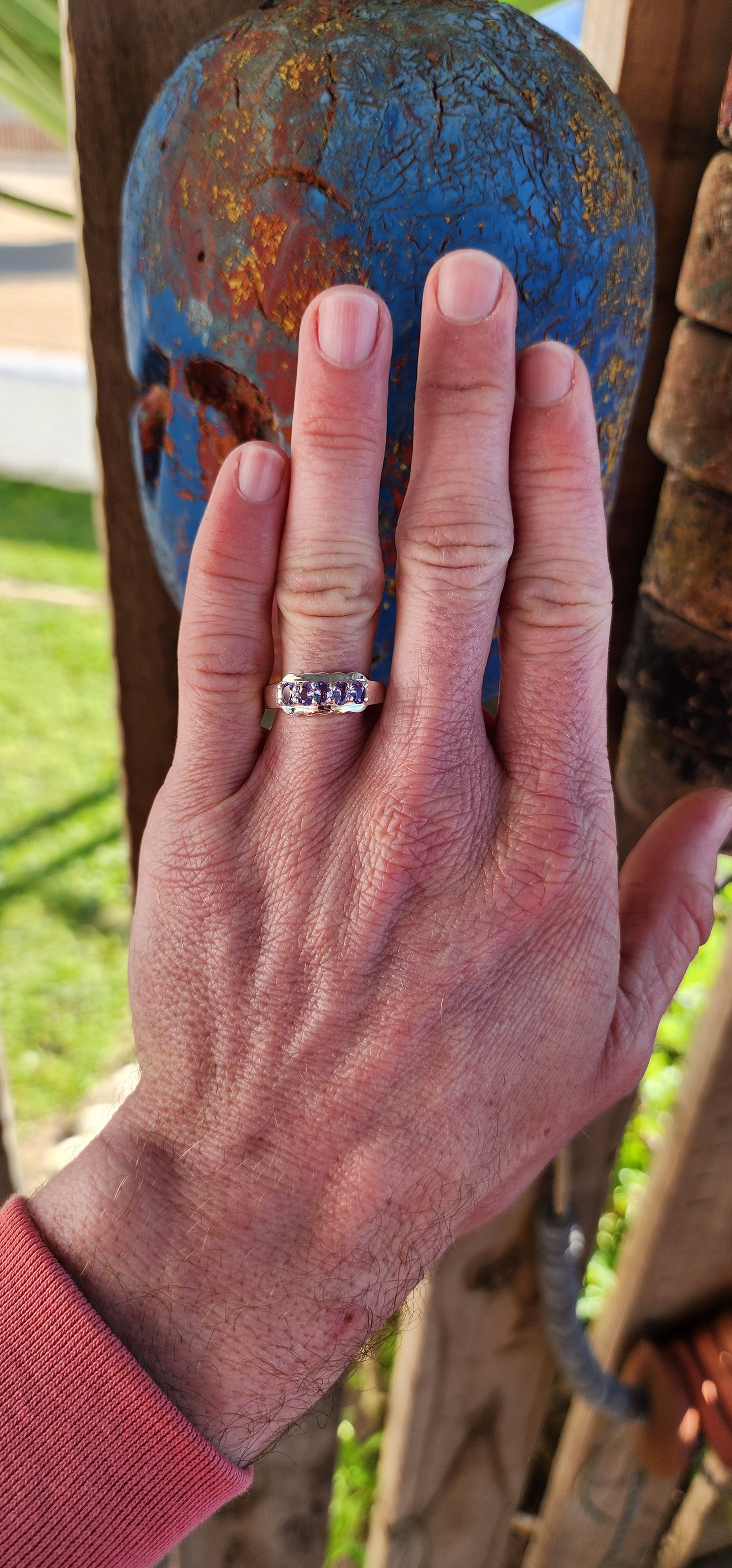 This exquisite Half Eternity style band featuring Natural Tanzanite Gemstones.