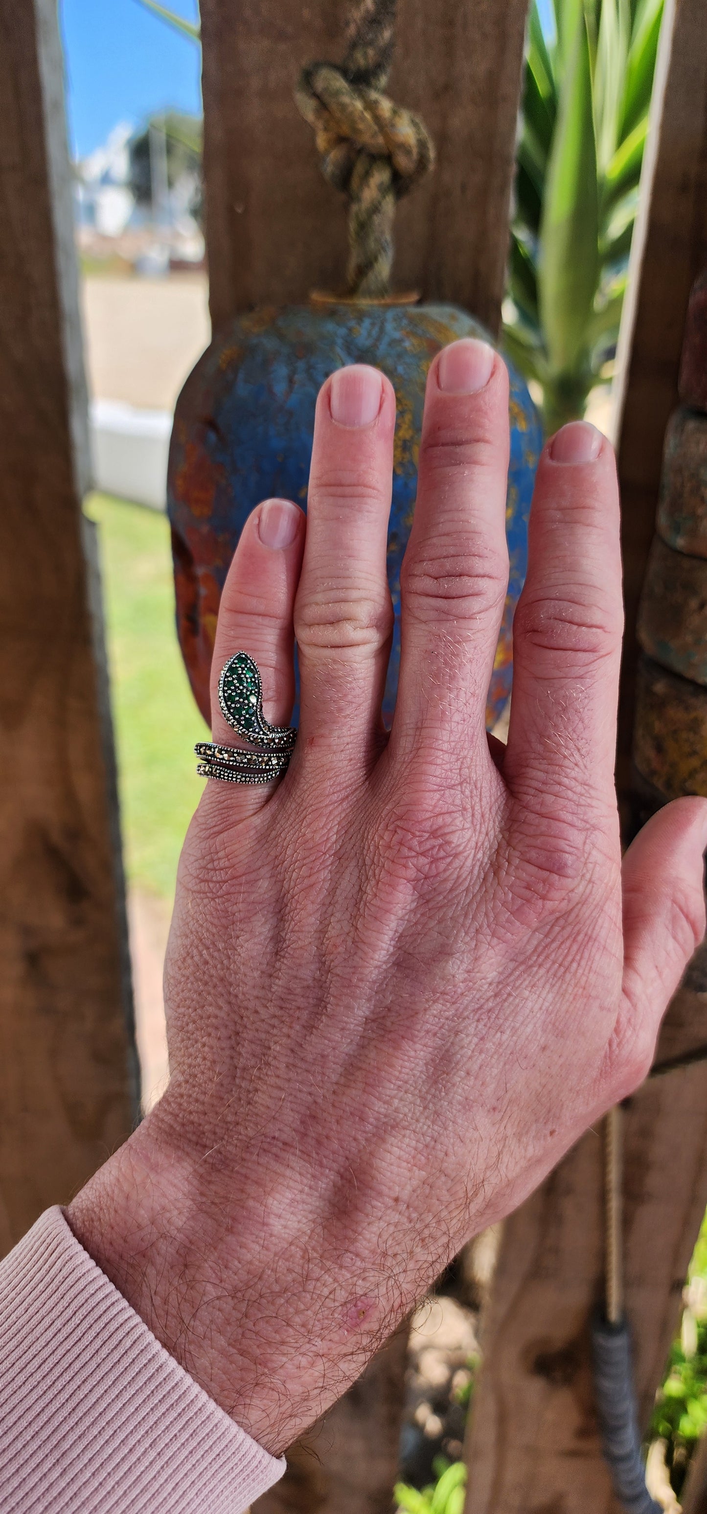 The elaborate Sterling Silver Serpent ring skillfully wraps itself around one's finger and heart.It has lovely scales composed of sparkly Marcasites, which shimmer beautifully in the light.