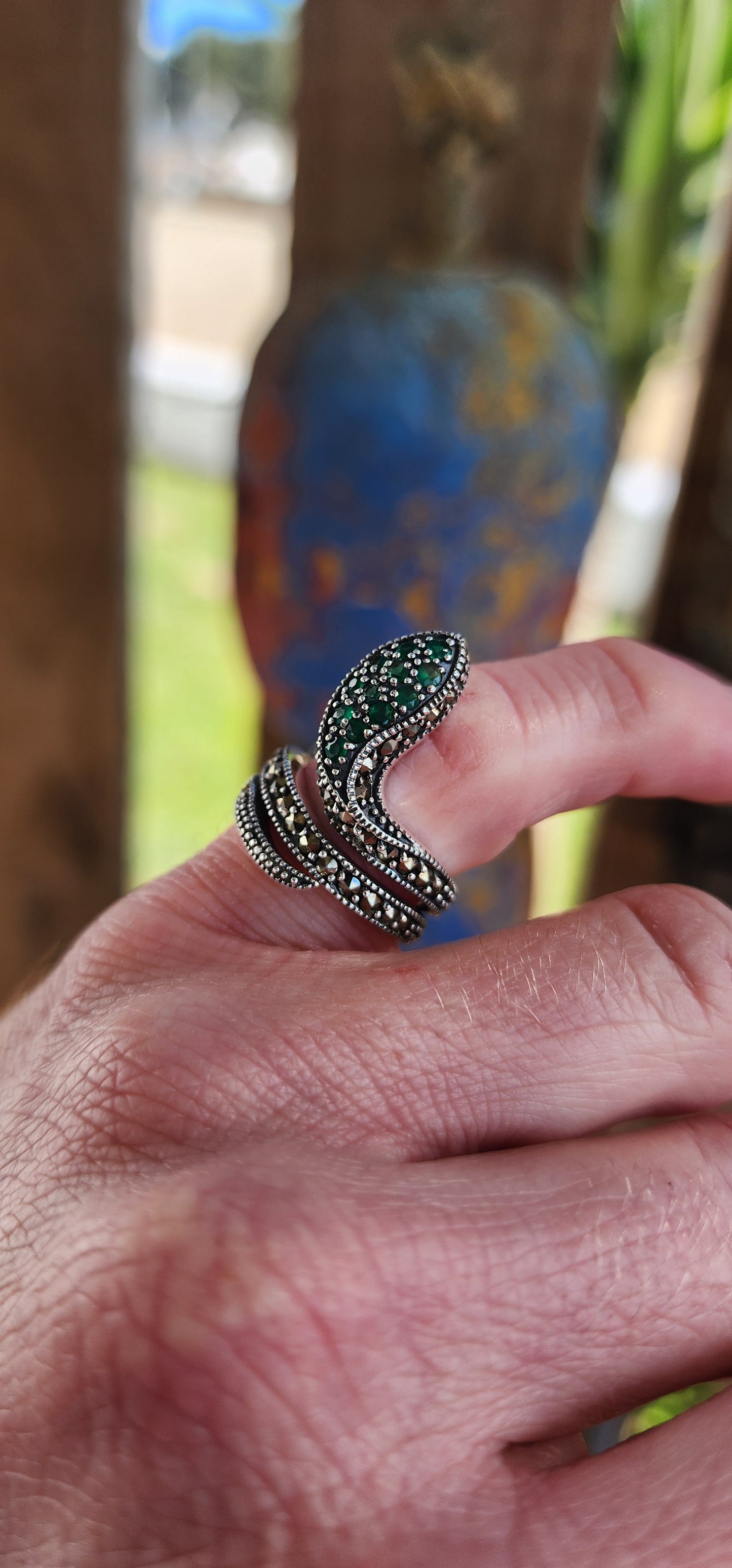 The elaborate Sterling Silver Serpent ring skillfully wraps itself around one's finger and heart.It has lovely scales composed of sparkly Marcasites, which shimmer beautifully in the light.