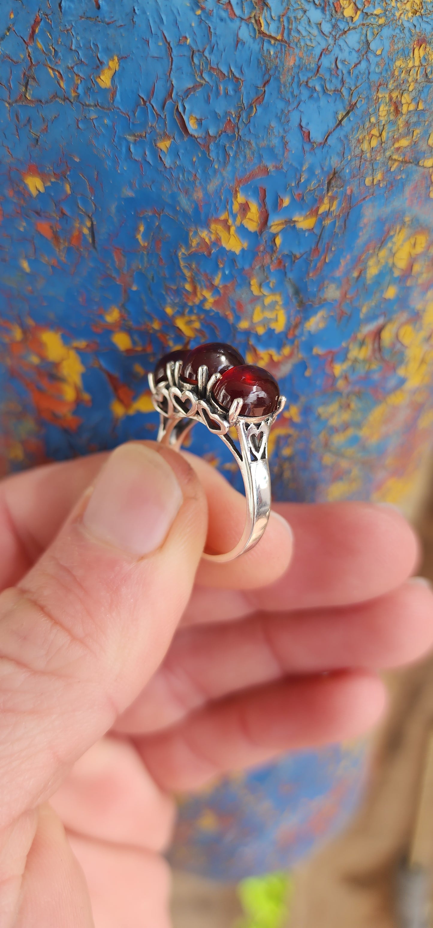 JELLY BABY!!Beautiful Sterling Silver and prong set Oval Garnet Cabochons Trilogy ring.
The little pierced Hearts on the sides of this ring add that extra special touch.