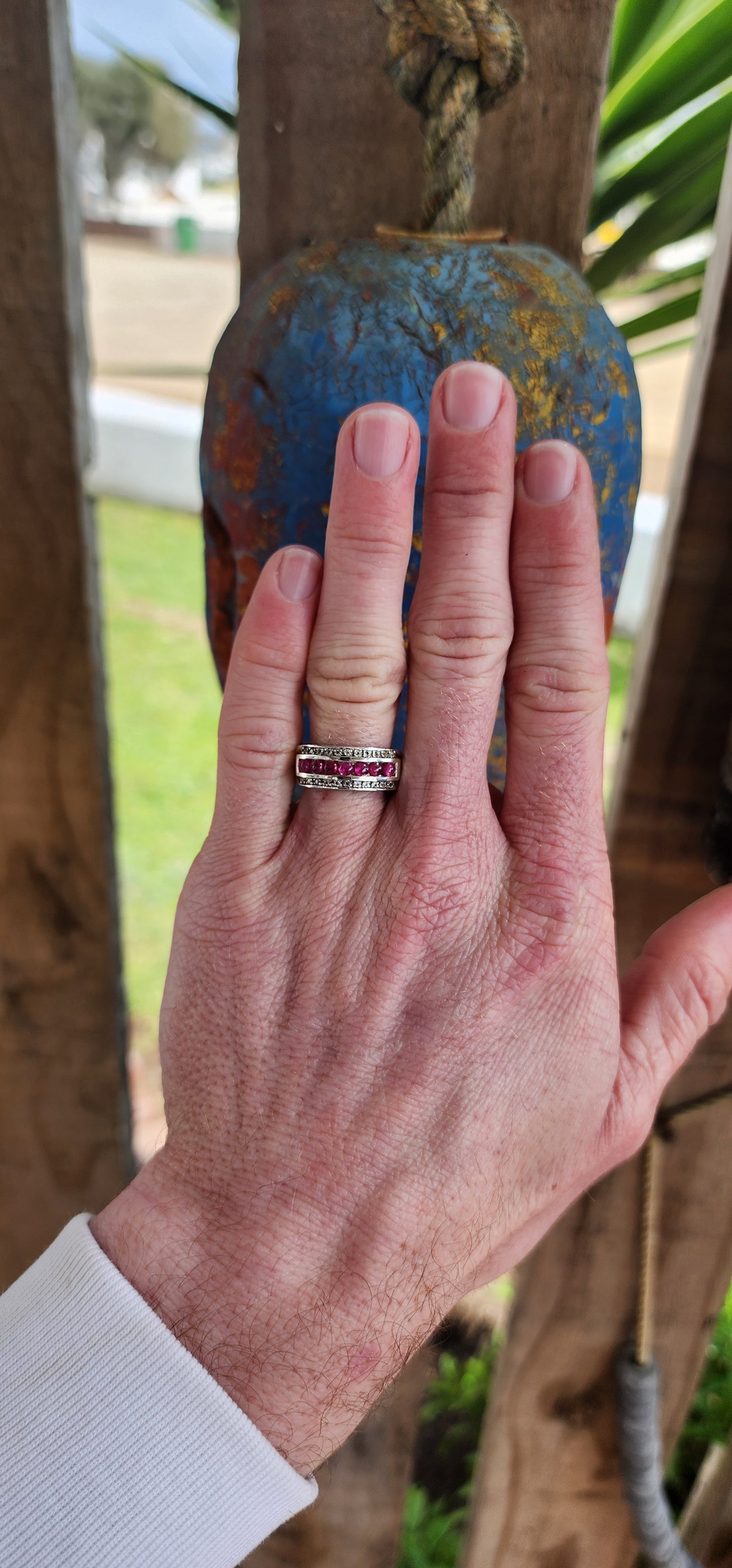 Classical 3 row Sterling Silver Art Deco style dress ring. Channel set with a row of 7 Ruby Cabochons in the centre and two rows of small Pave set CZ Gemstones on the sides.