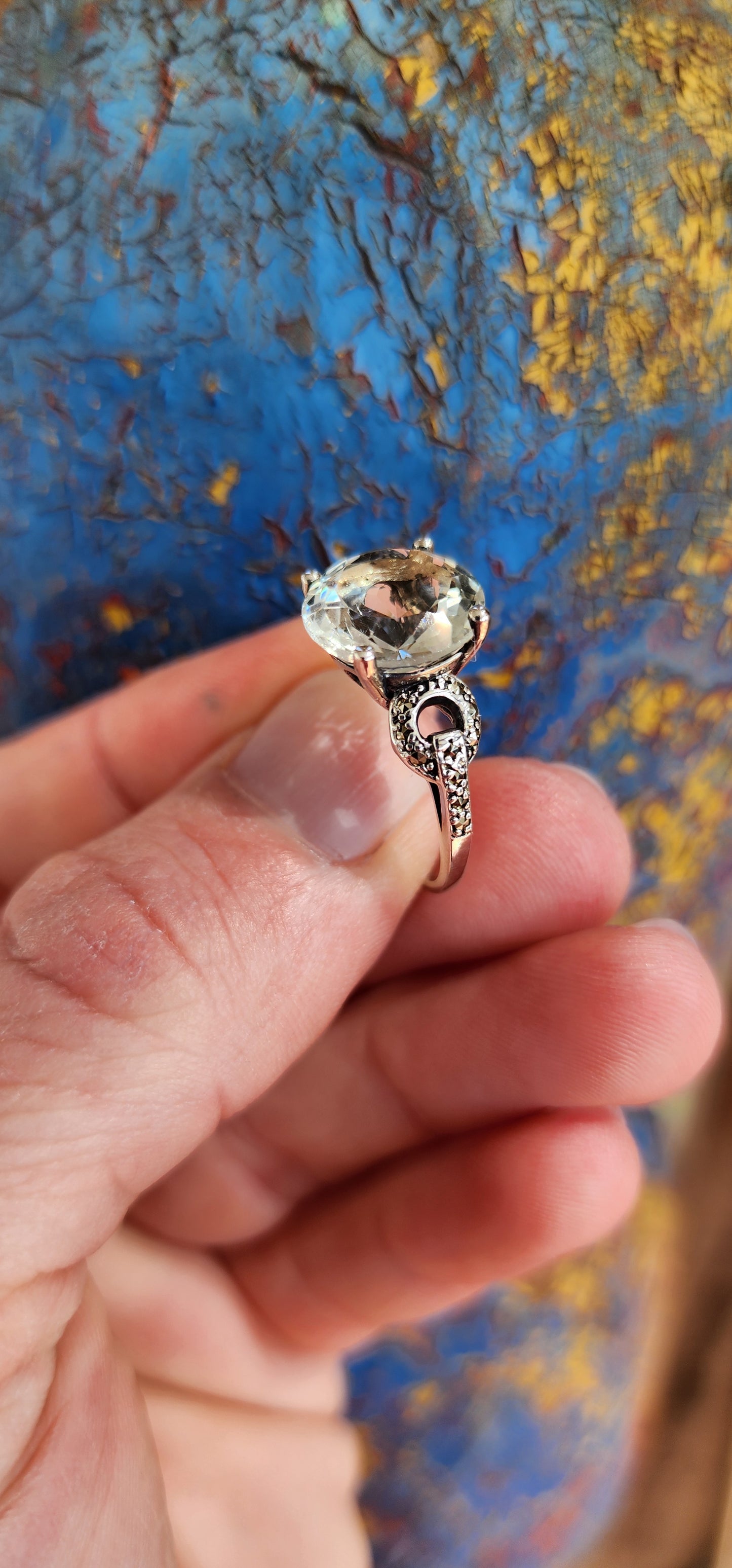 This alluring Sterling Silver cocktail/dress ring features a generous in size Round cut Prasiolite "Green Amethyst"Gemstone in the centre, prong set in a ornate pierced Gallery basket .Marcasite studded Circles adorn the shoulders/sides of the ring.