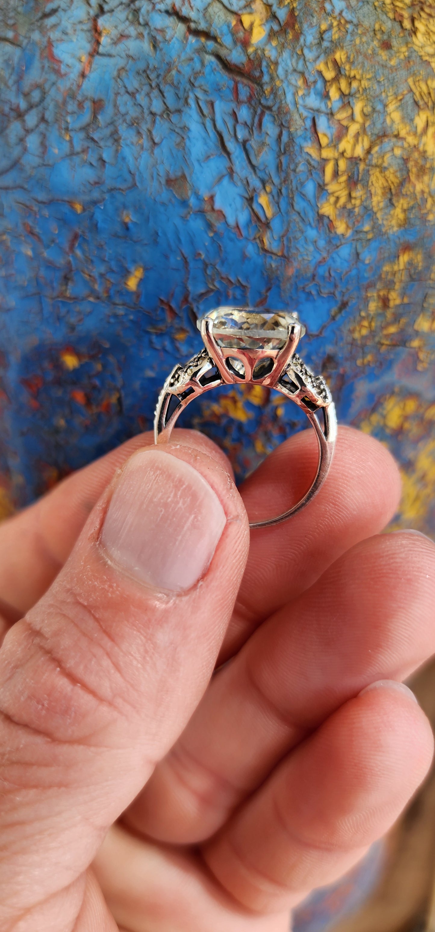 This alluring Sterling Silver cocktail/dress ring features a generous in size Round cut Prasiolite "Green Amethyst"Gemstone in the centre, prong set in a ornate pierced Gallery basket .Marcasite studded Circles adorn the shoulders/sides of the ring.