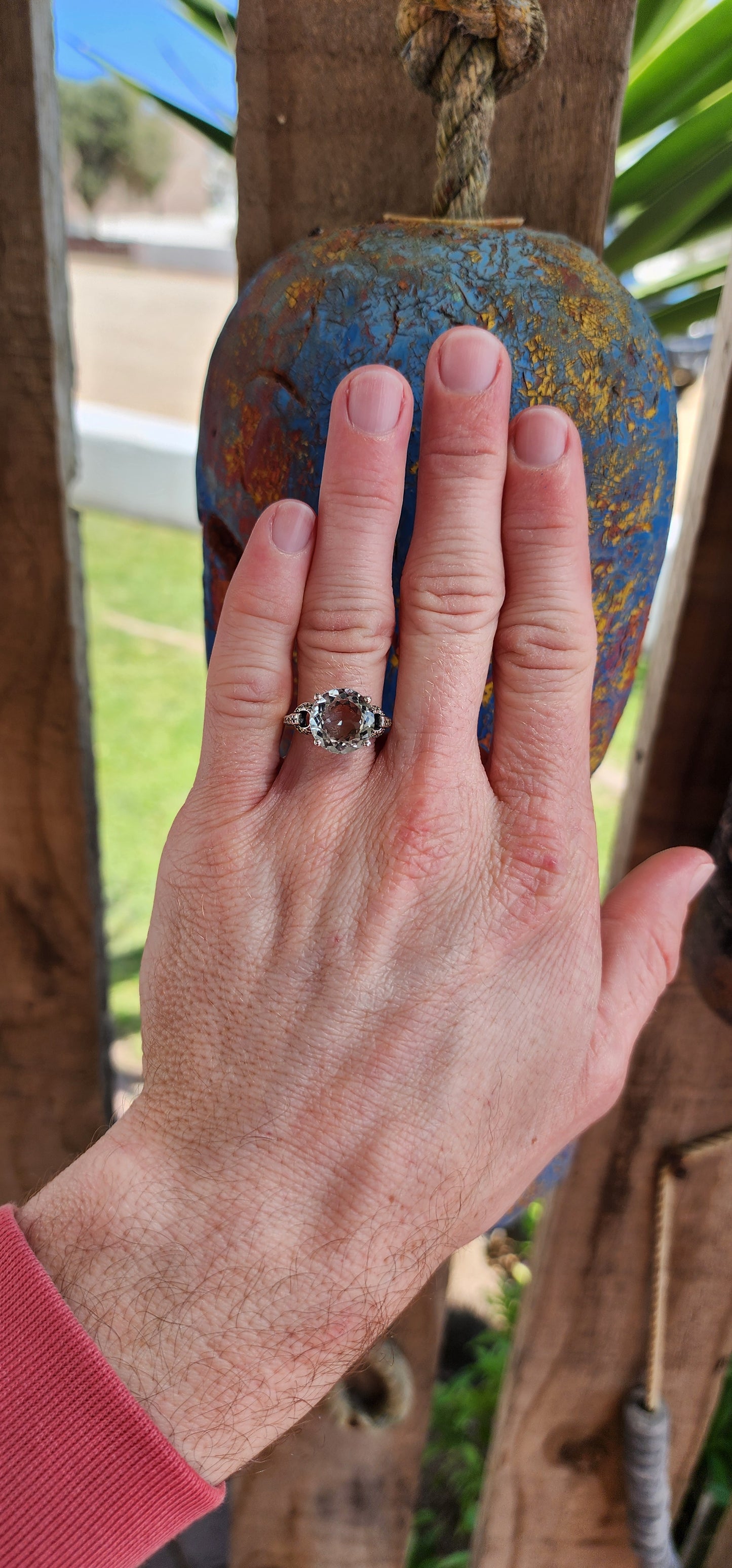 This alluring Sterling Silver cocktail/dress ring features a generous in size Round cut Prasiolite "Green Amethyst"Gemstone in the centre, prong set in a ornate pierced Gallery basket .Marcasite studded Circles adorn the shoulders/sides of the ring.