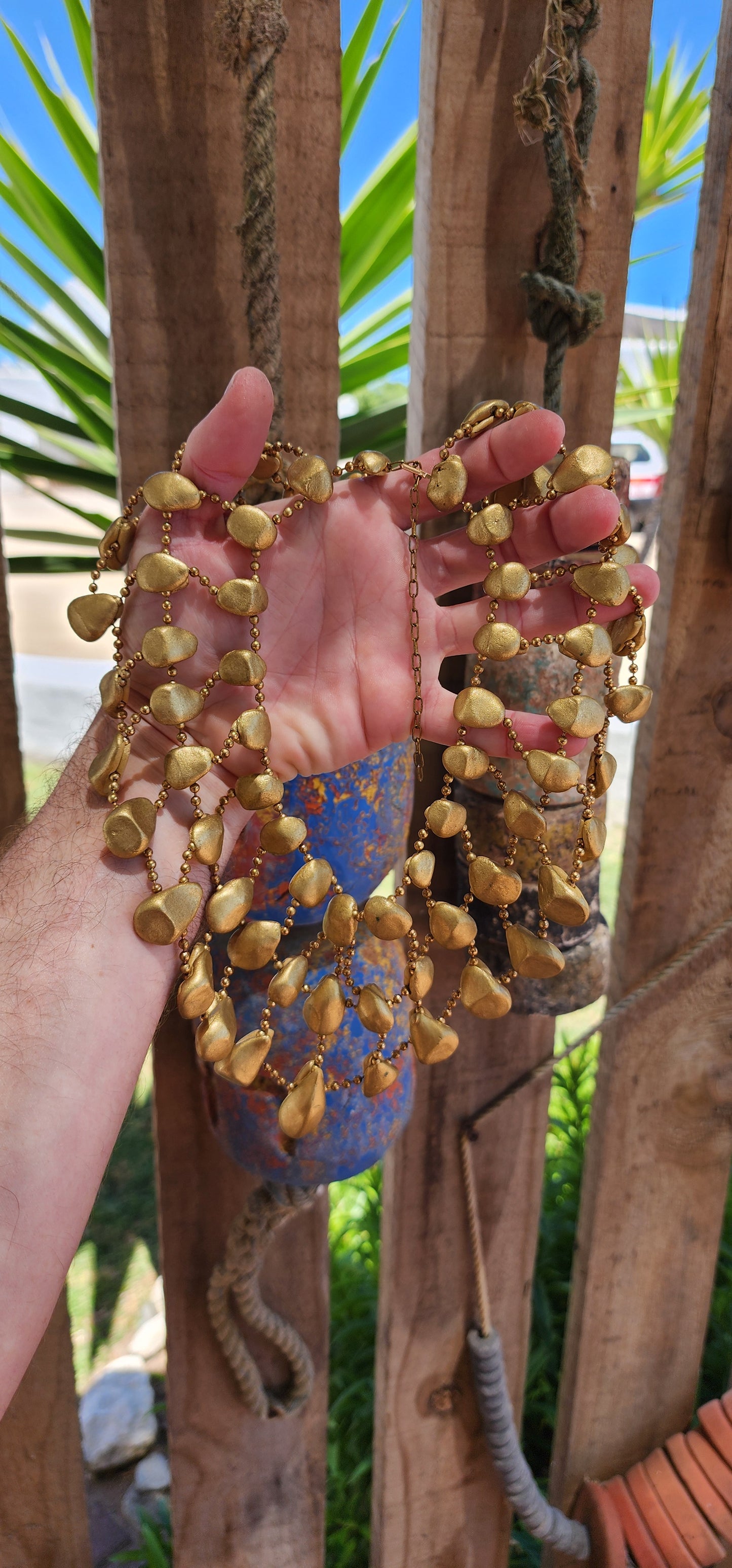 Get ready to channel your inner queen with this jaw-dropping artisan made statement necklace!Crafted from goldtone clay pebbles and Brass chains.