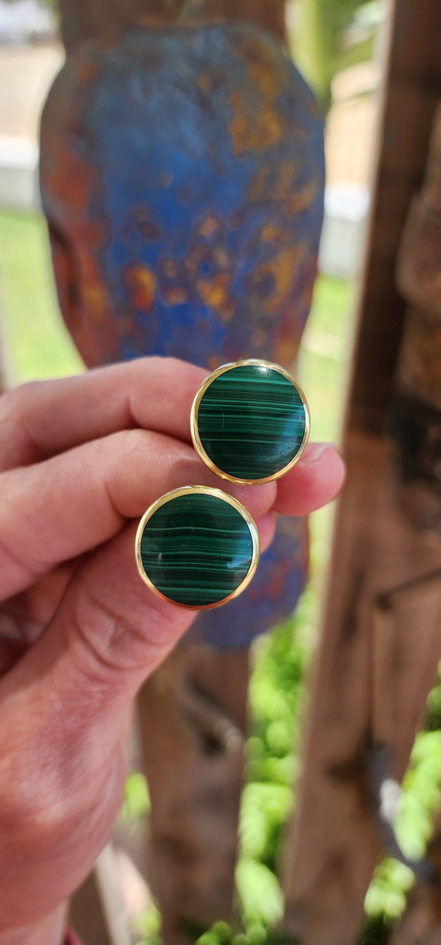 These vintage brass and malachite clip-on earrings exude a bold, modernist flair.