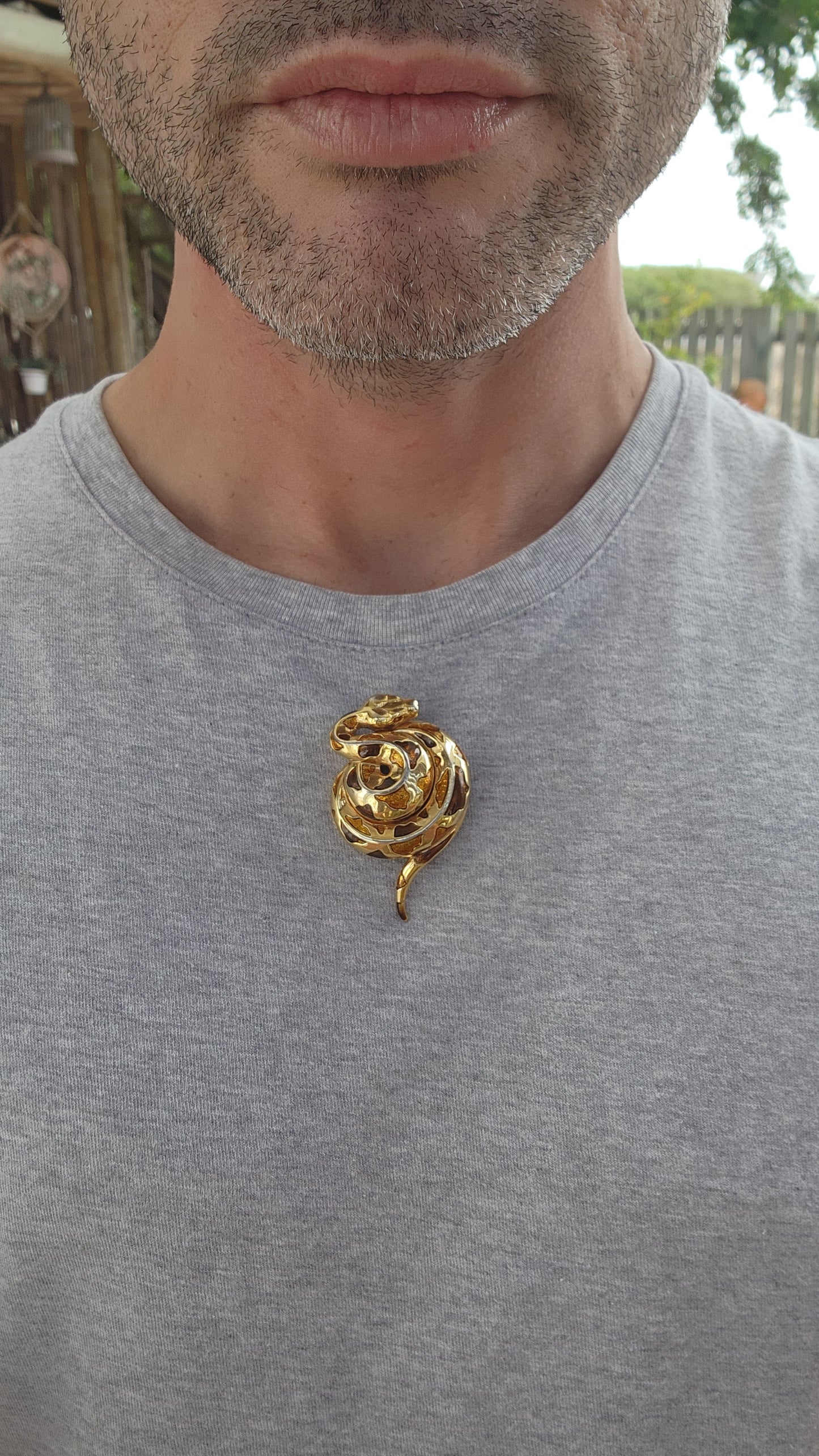 This exquisite vintage 1980s costume brooch captures the serpentine grace and allure of its subject. Designed as a coiled serpent, the brooch is masterfully crafted in gold-plated metal, exuding a warm, luxurious glow.