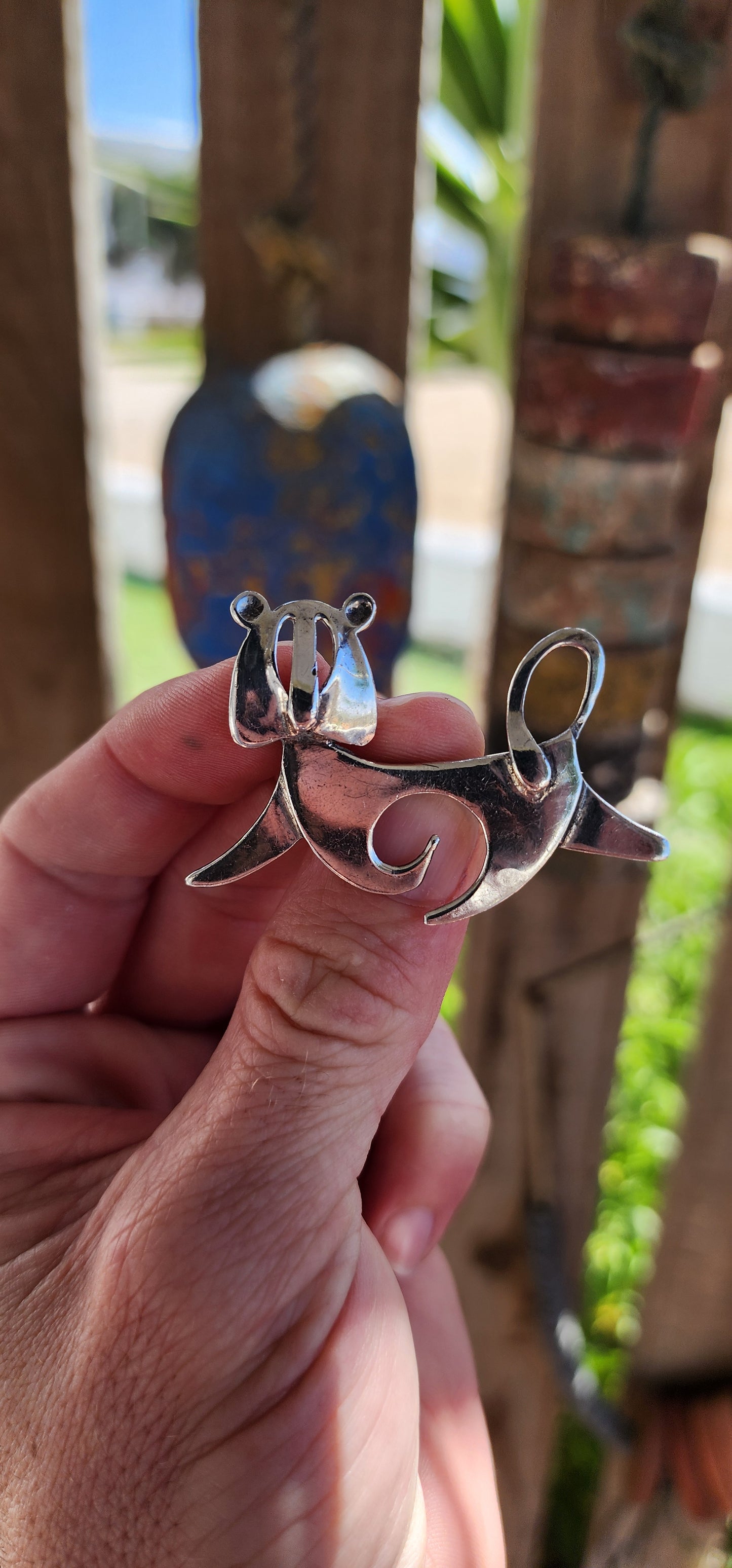 This mid-century modernist lion brooch is a striking and whimsical piece of wearable art, blending clean, abstract design with playful charm.
