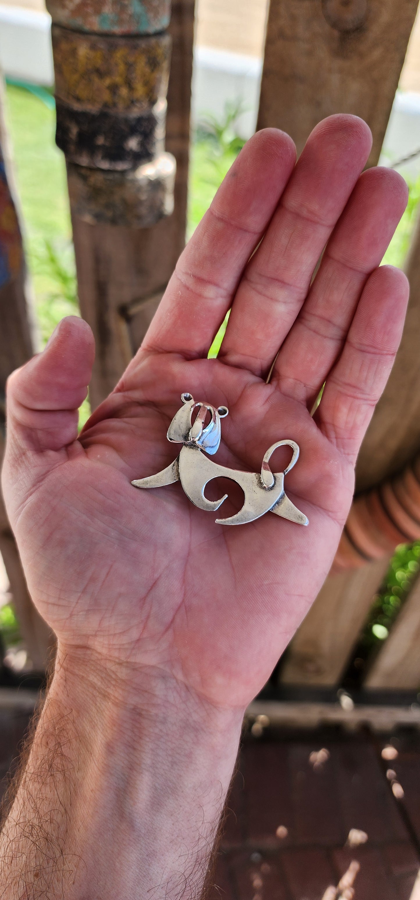 This mid-century modernist lion brooch is a striking and whimsical piece of wearable art, blending clean, abstract design with playful charm.