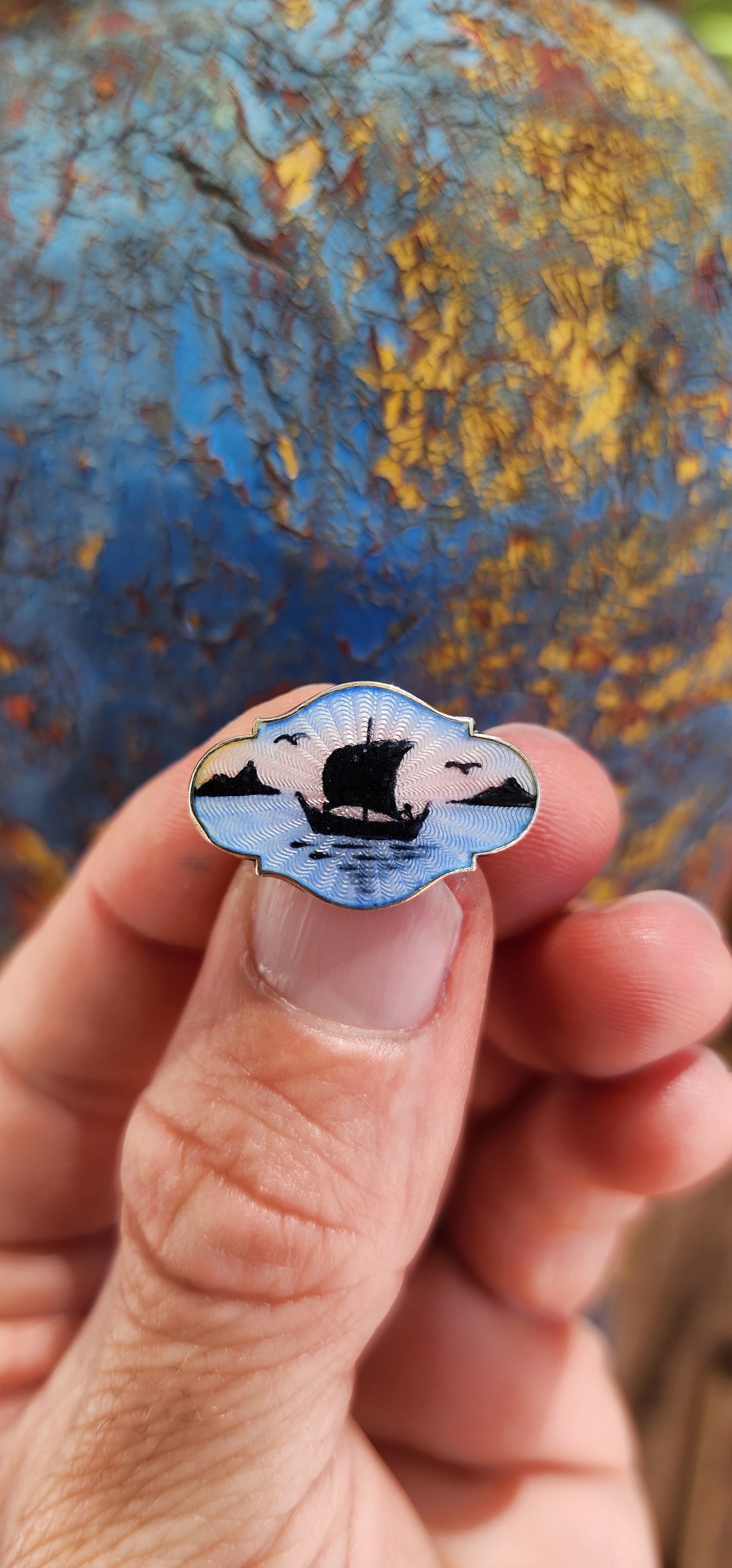 This petite vintage sterling silver and enamel brooch is a Scandinavian piece crafted by Danish silversmith Gert Rasmussen in the 1980s.
