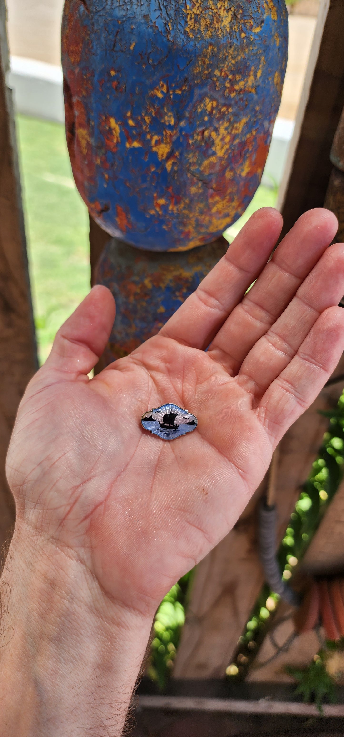This petite vintage sterling silver and enamel brooch is a Scandinavian piece crafted by Danish silversmith Gert Rasmussen in the 1980s.