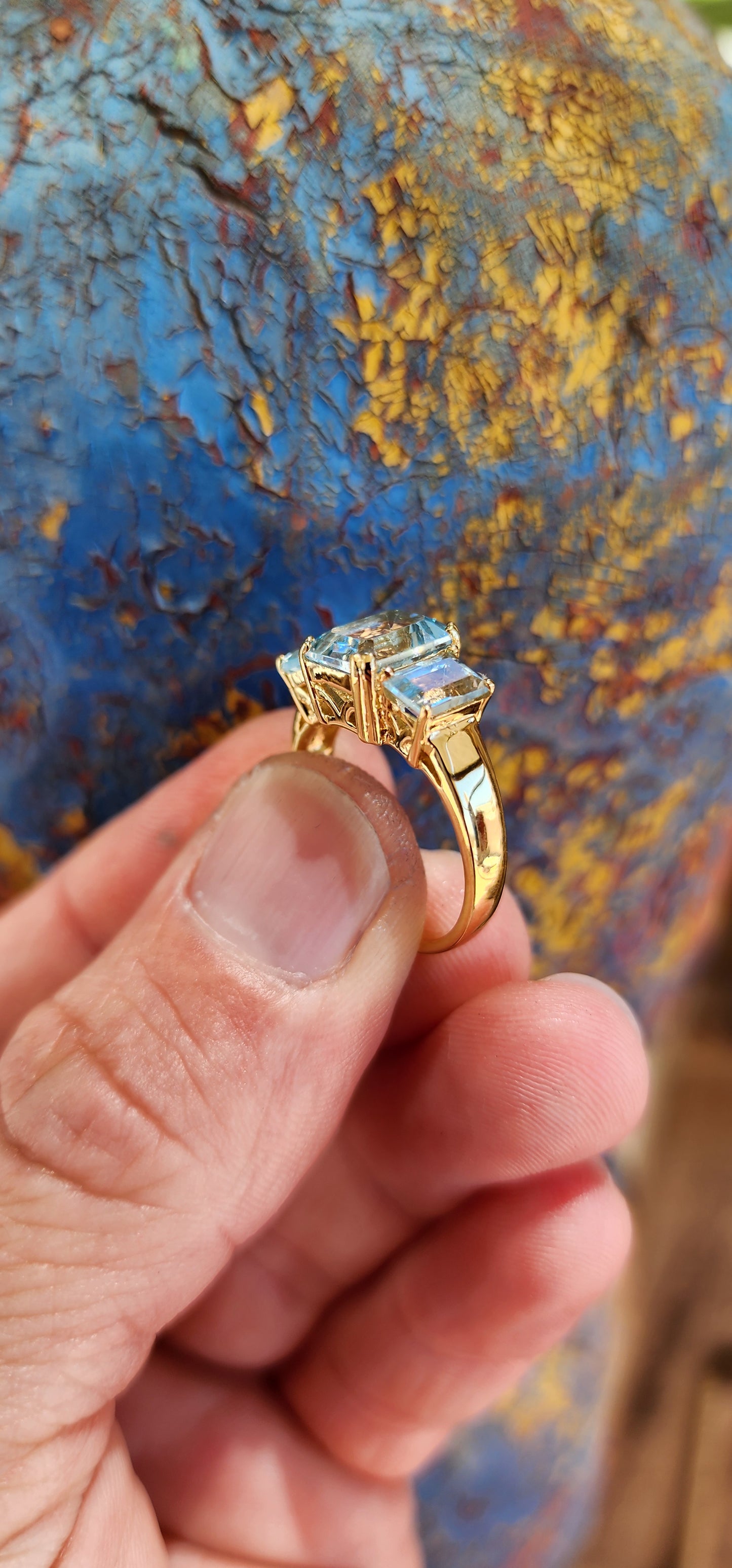 This extraordinary sterling silver trilogy ring, elegantly plated with 18ct yellow gold, radiates timeless sophistication and an ethereal charm.