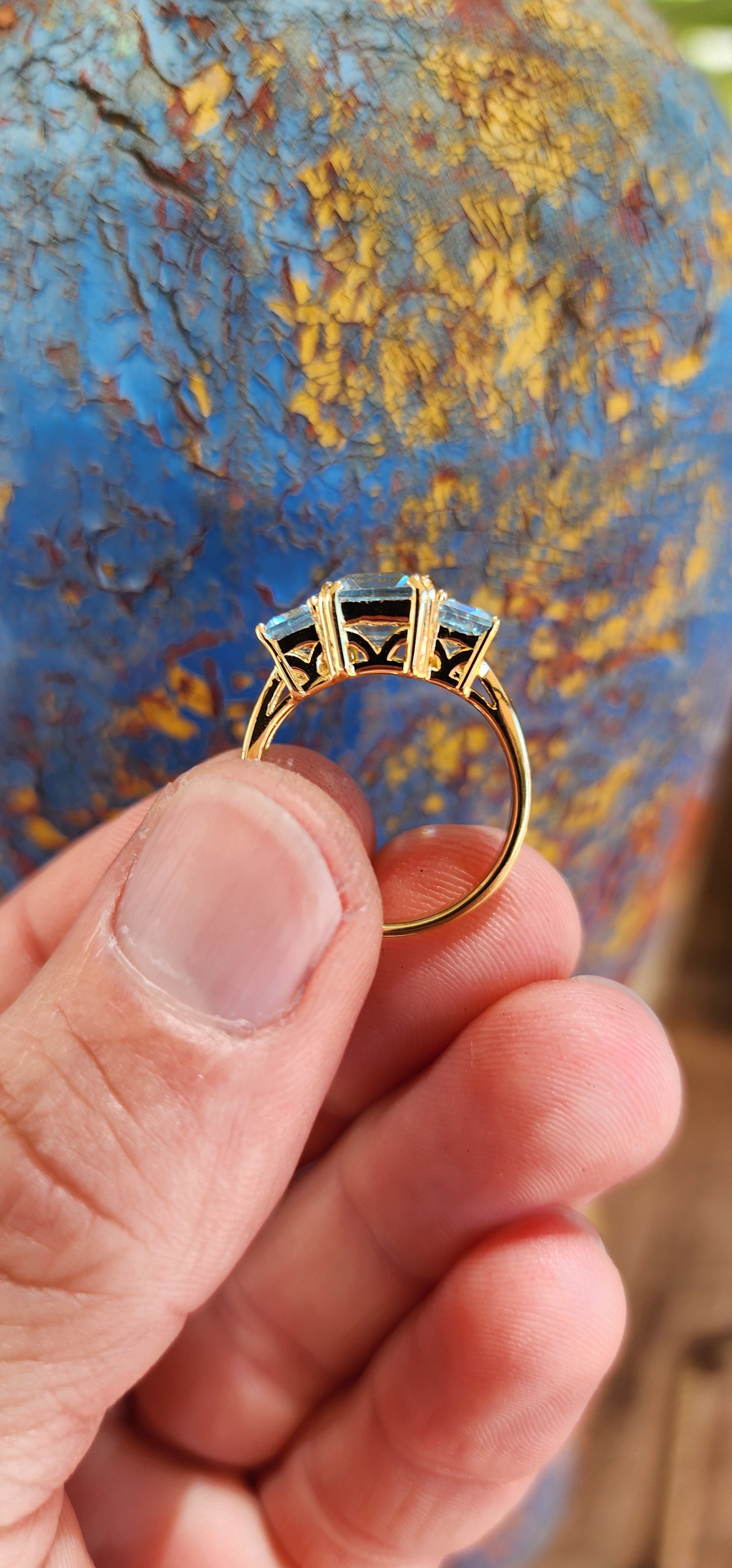 This extraordinary sterling silver trilogy ring, elegantly plated with 18ct yellow gold, radiates timeless sophistication and an ethereal charm.