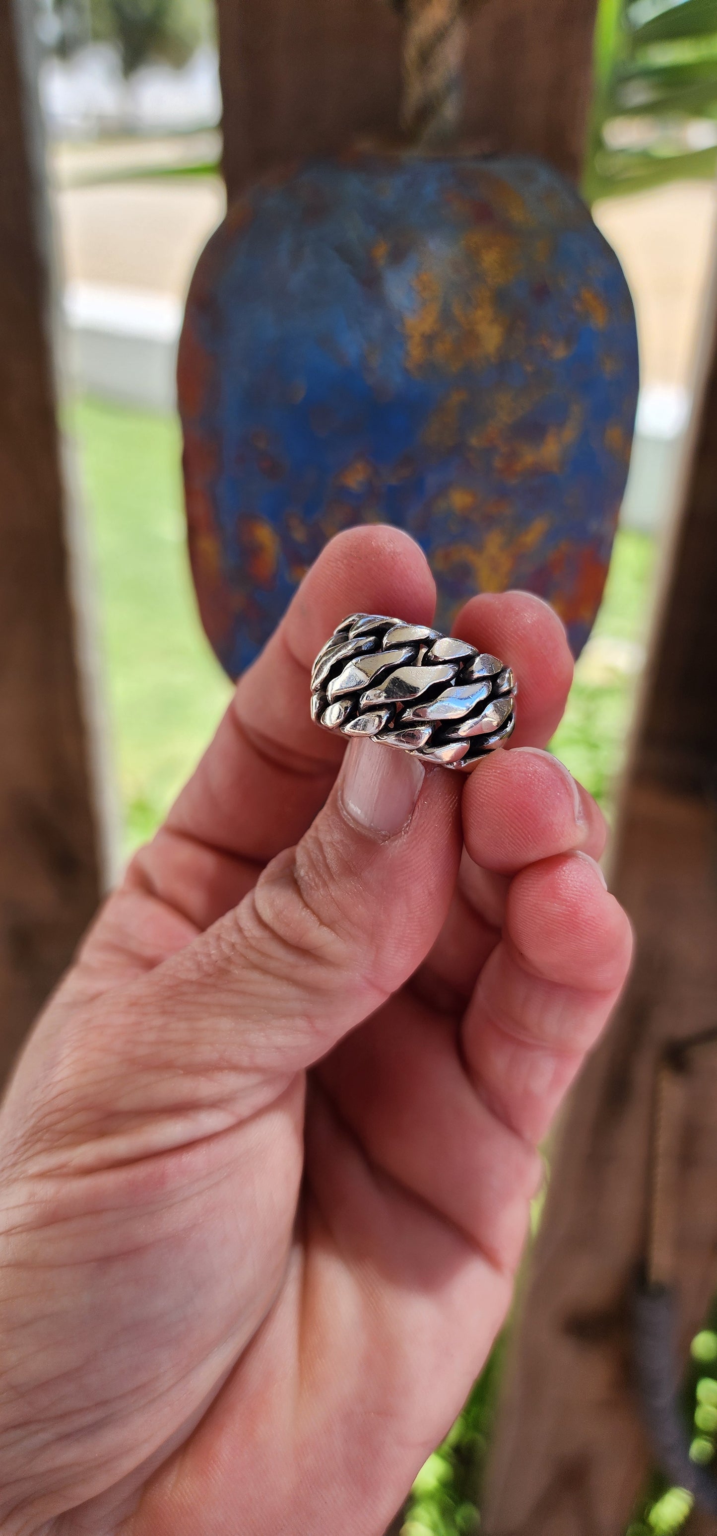 The ring is a chunky sterling silver design from the Buddha to Buddha "Ben Collection",crafted for men or as a unisex piece, perfect for a bold pinky ring. The piece features a braided chain design, giving it a rugged yet polished aesthetic.