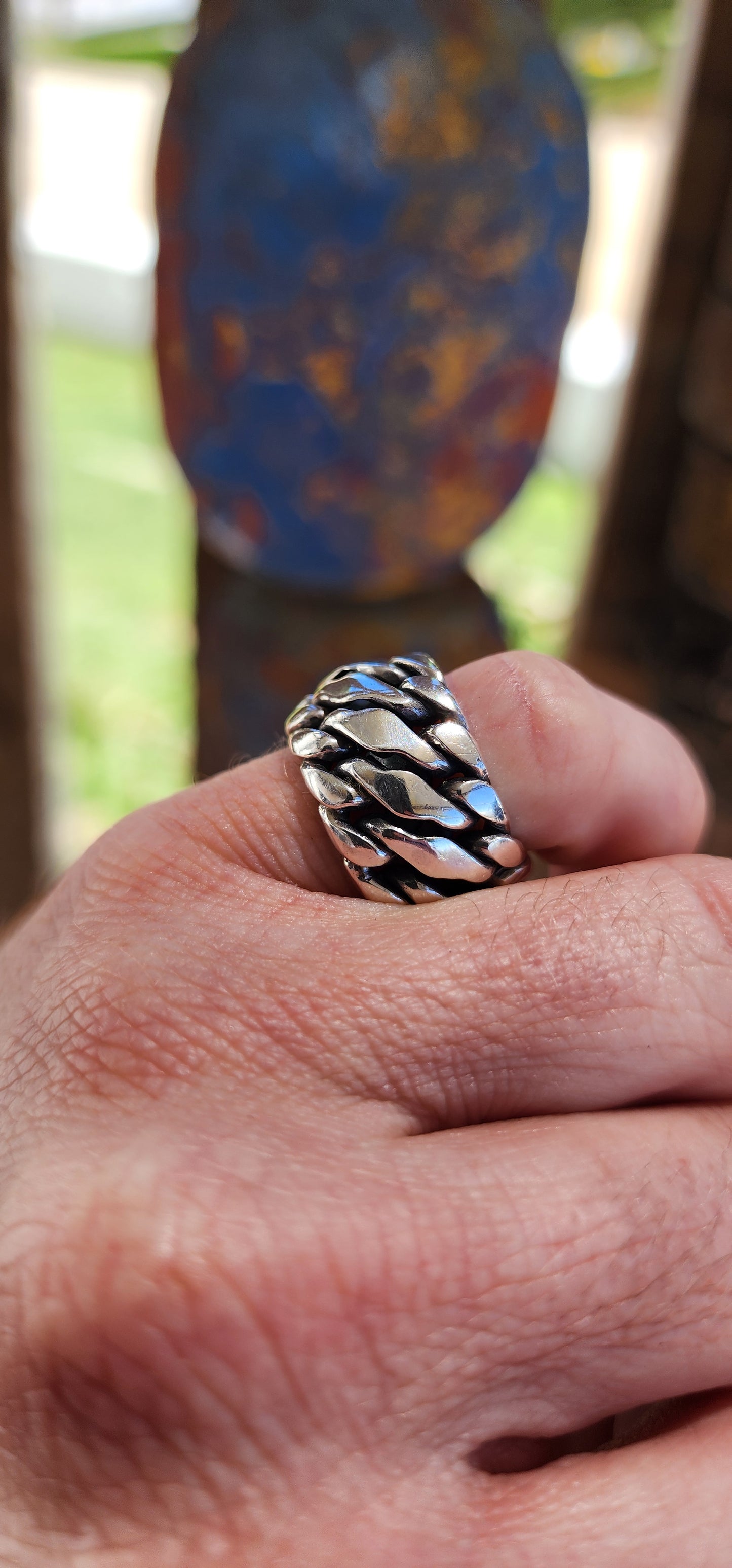 The ring is a chunky sterling silver design from the Buddha to Buddha "Ben Collection",crafted for men or as a unisex piece, perfect for a bold pinky ring. The piece features a braided chain design, giving it a rugged yet polished aesthetic.