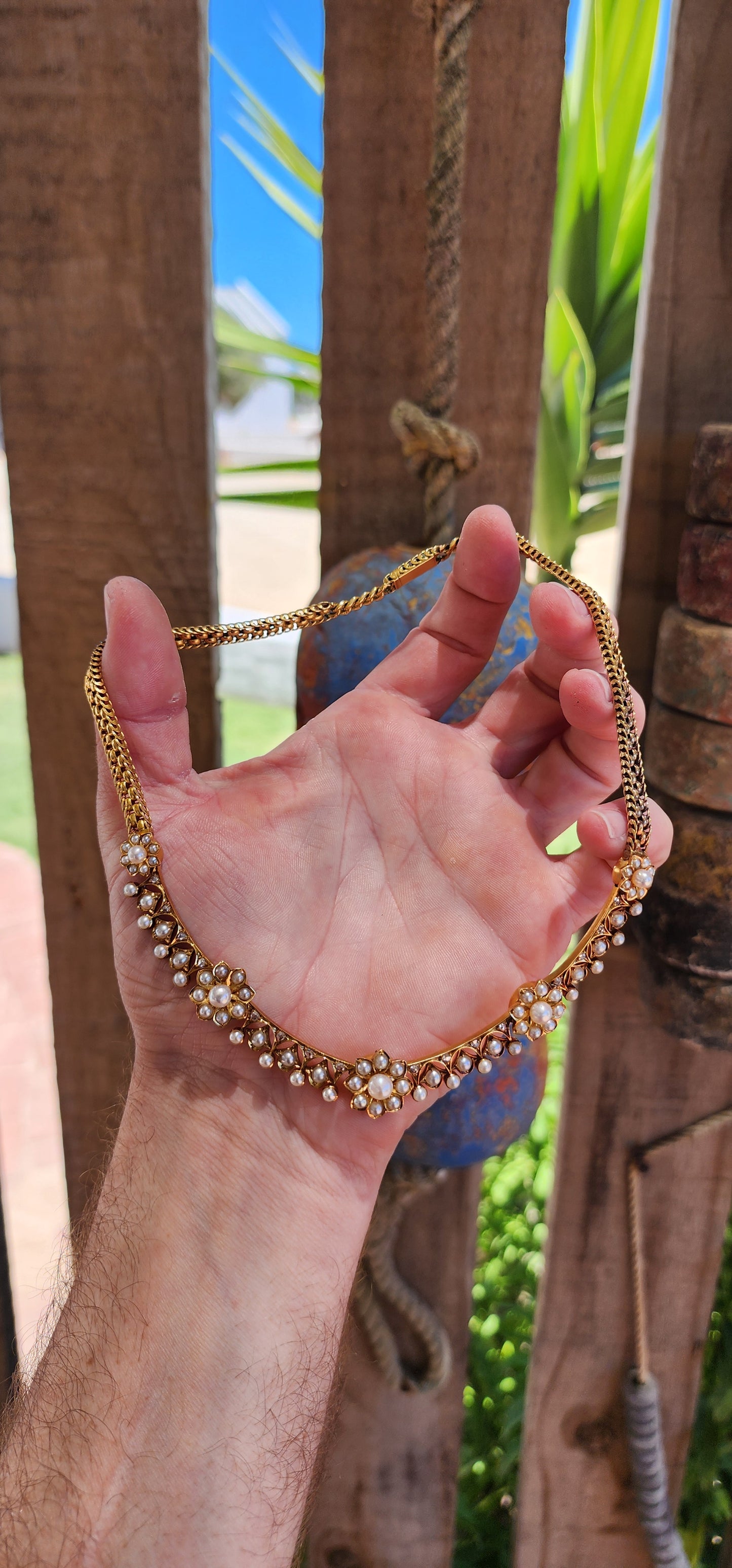This magnificent antique necklace is a Victorian-era masterpiece crafted in solid 18ct yellow gold, featuring marine cultured pearls and old rose-cut diamonds.