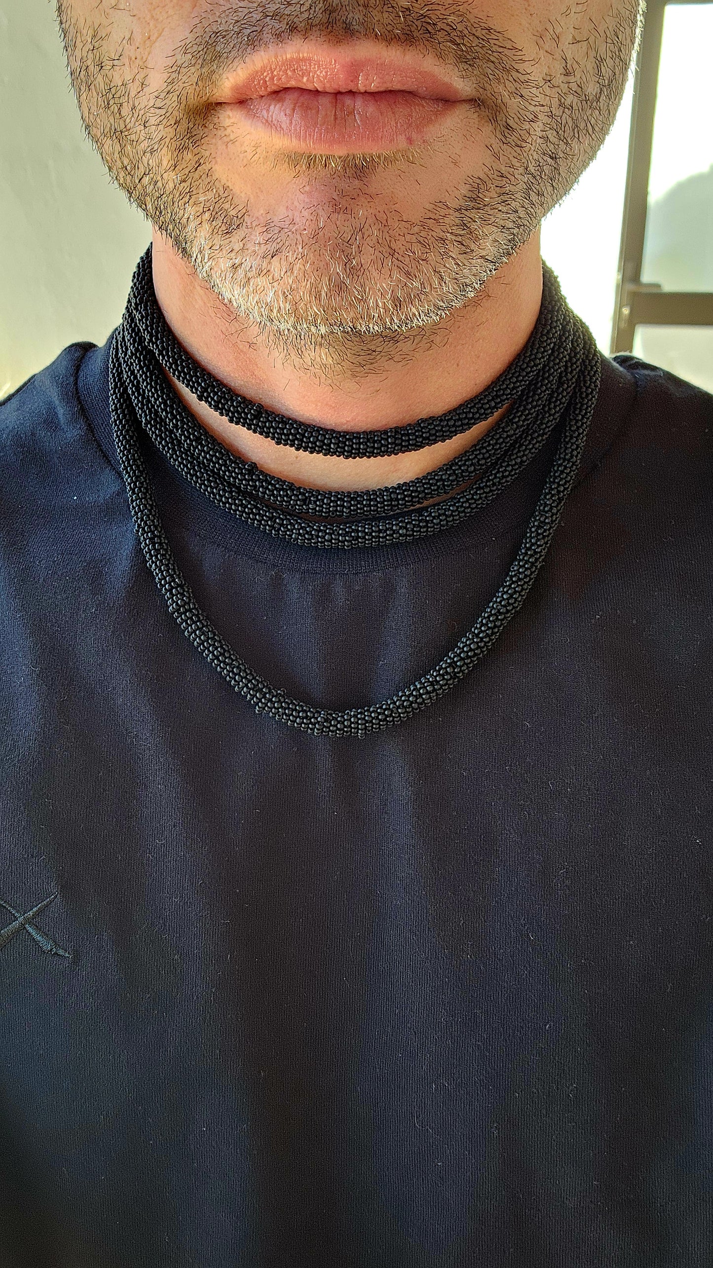 This exquisite handcrafted choker necklace is a true testament to skilled artistry and precision. Featuring four strands of finely detailed tubular crochet beadwork.
