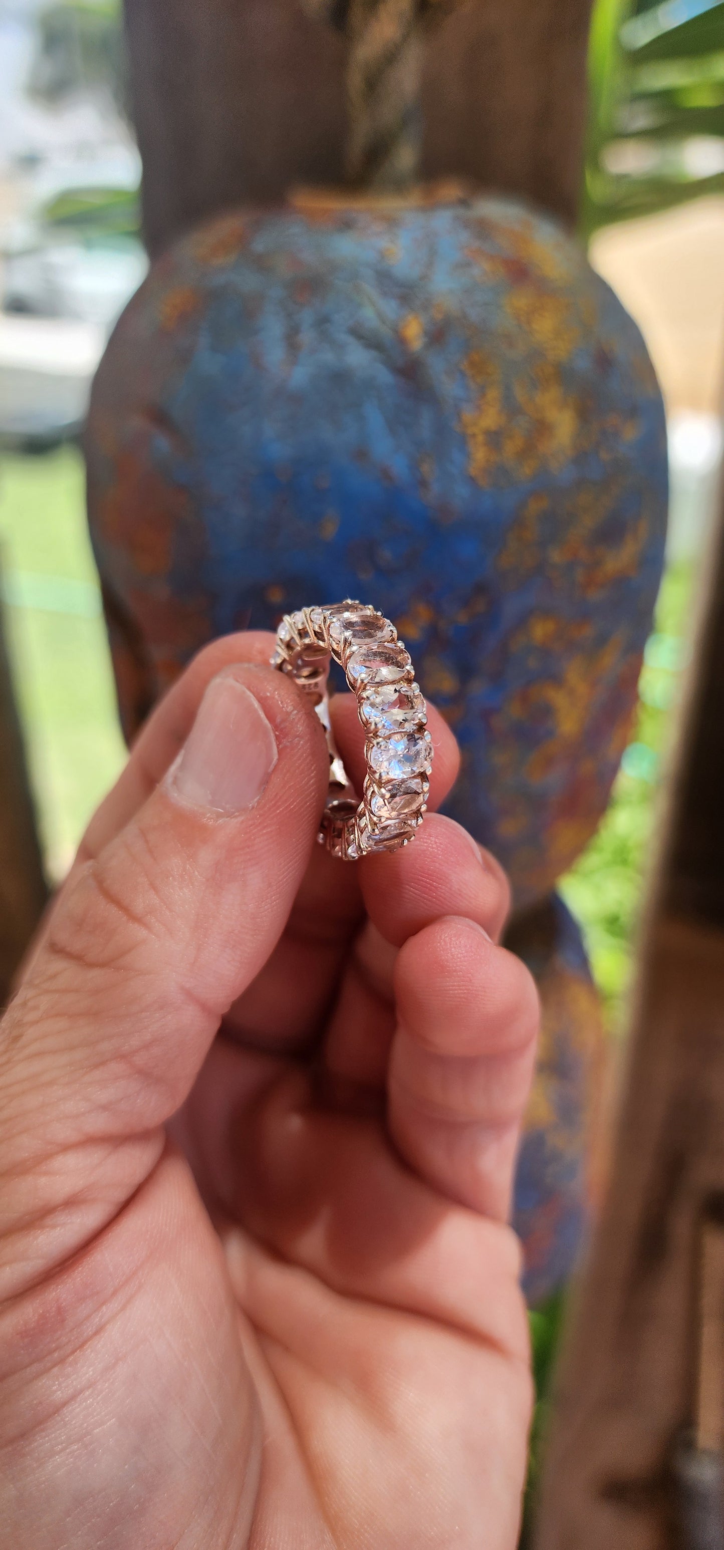 This exquisite full eternity ring is a true statement of refined elegance and beauty. Crafted from sterling silver, it features 17 oval-cut morganite gemstones, each meticulously prong-set in a continuous, seamless band.