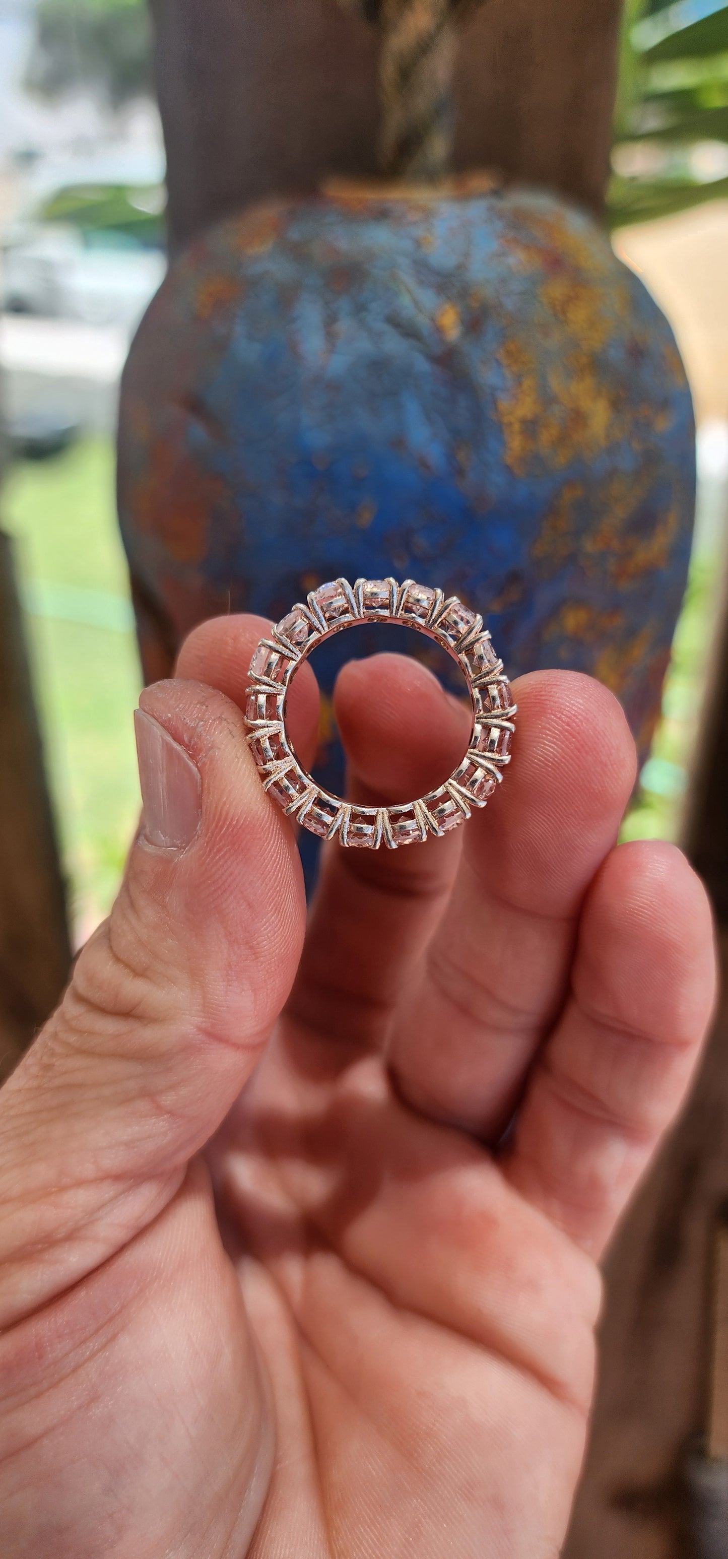 This exquisite full eternity ring is a true statement of refined elegance and beauty. Crafted from sterling silver, it features 17 oval-cut morganite gemstones, each meticulously prong-set in a continuous, seamless band.
