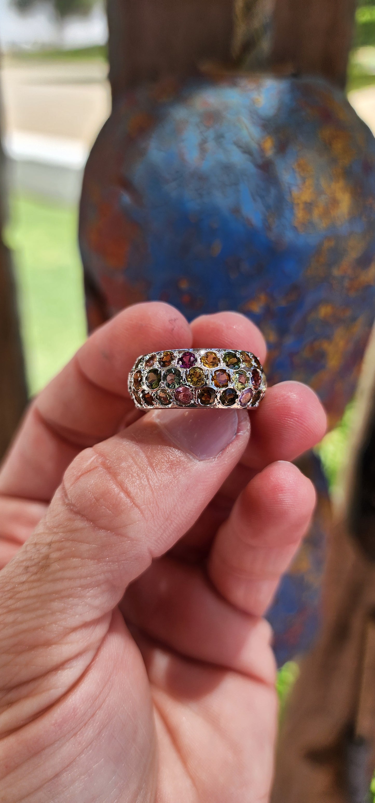 This full eternity ring is like a miniature carnival for your hand—a vibrant, joyful spectacle that refuses to be ignored! Its chunky domed design makes it a bold centerpiece, while the multicolored tourmalines are the stars of the show.