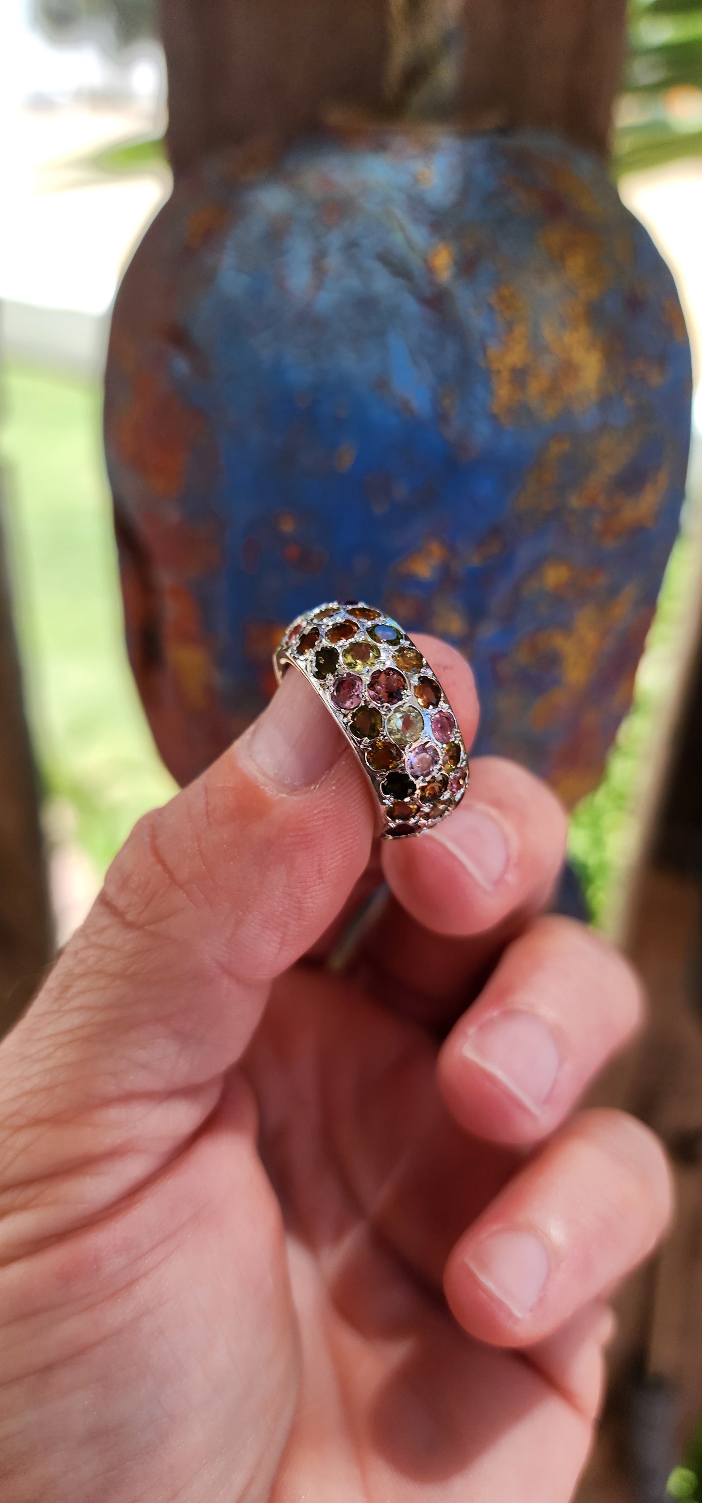 This full eternity ring is like a miniature carnival for your hand—a vibrant, joyful spectacle that refuses to be ignored! Its chunky domed design makes it a bold centerpiece, while the multicolored tourmalines are the stars of the show.