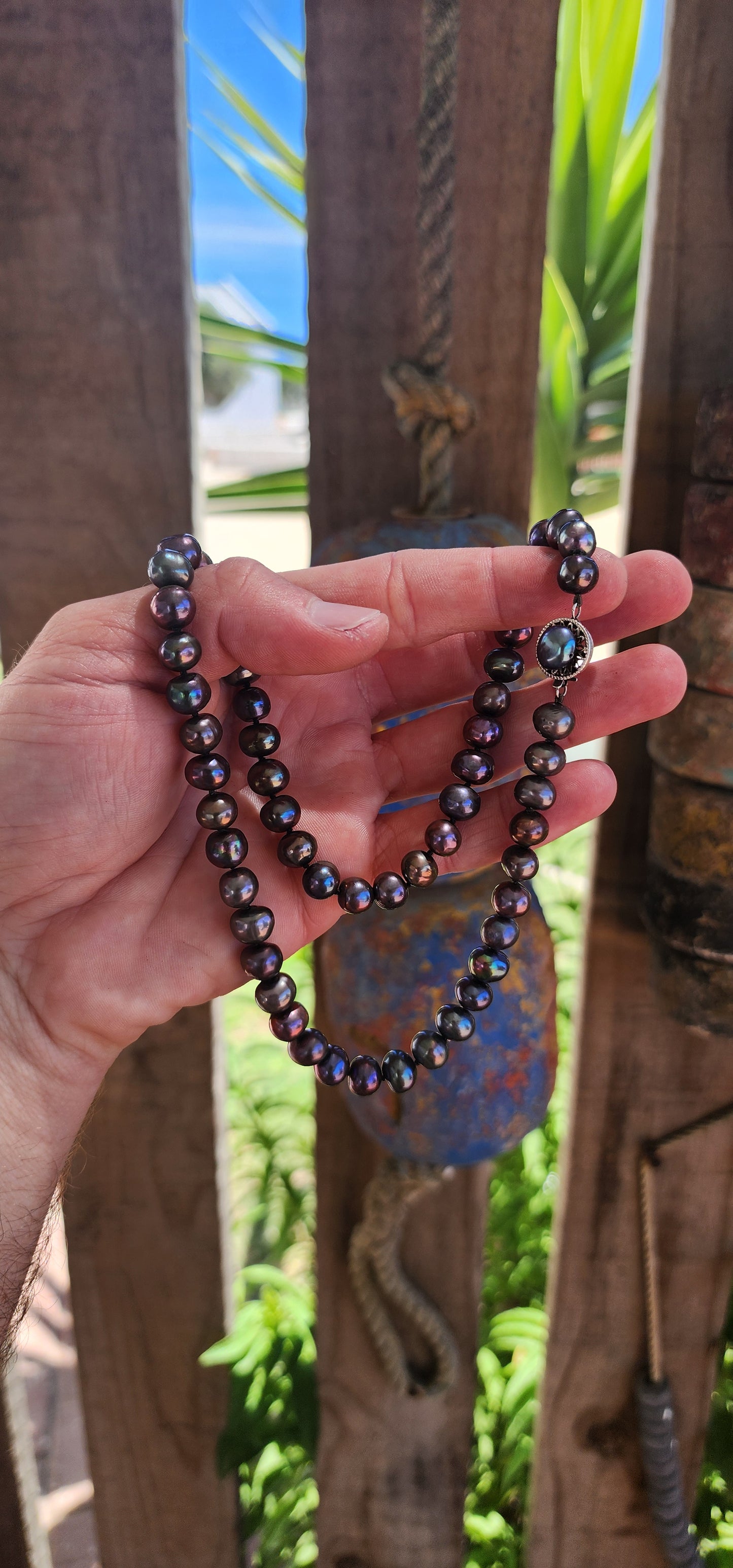 This exquisite necklace showcases the perfect harmony of nature’s beauty and artisanal craftsmanship. Composed of hand-selected freshwater black pearls, each pearl is a semi-round freeform shape, offering a unique and organic aesthetic.