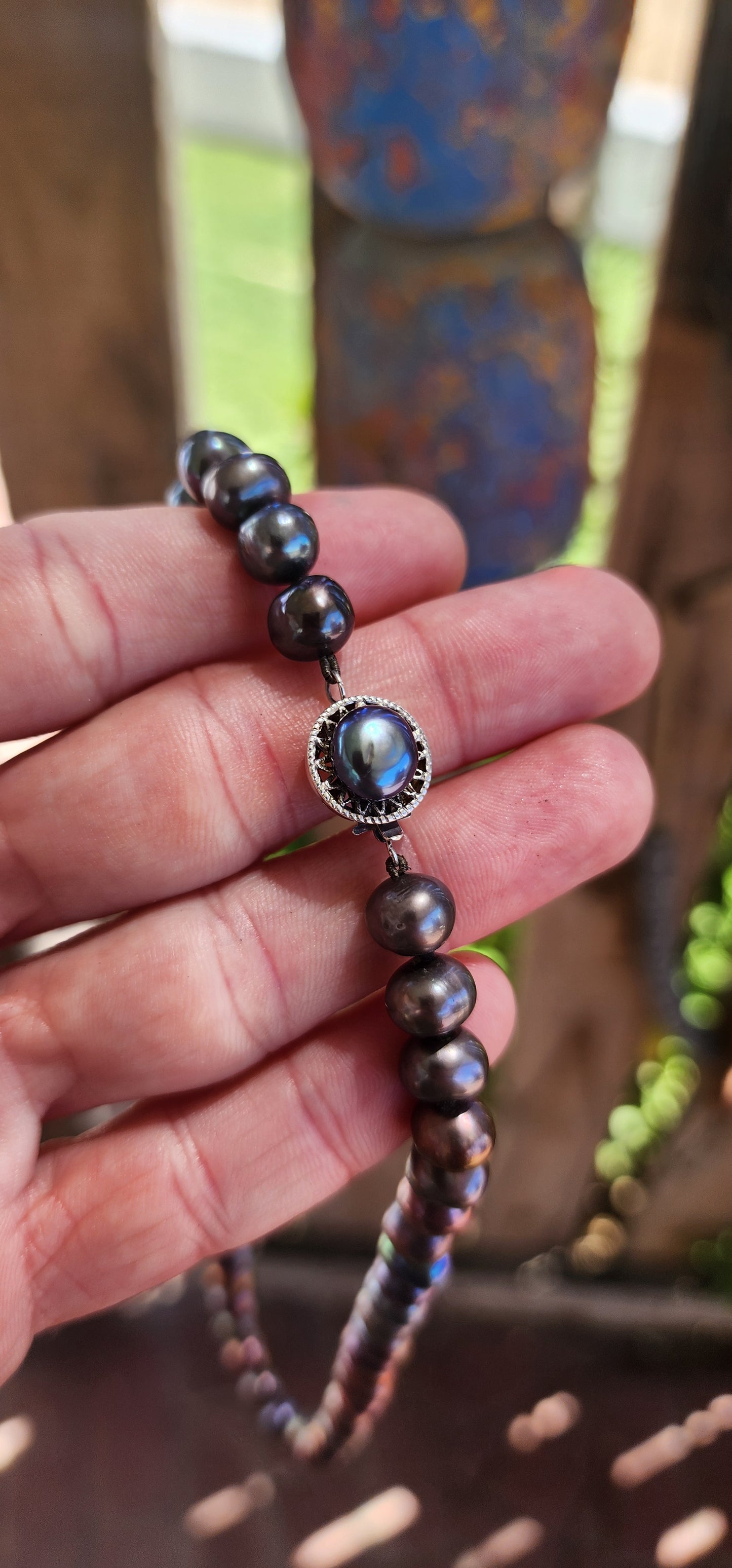 This exquisite necklace showcases the perfect harmony of nature’s beauty and artisanal craftsmanship. Composed of hand-selected freshwater black pearls, each pearl is a semi-round freeform shape, offering a unique and organic aesthetic.