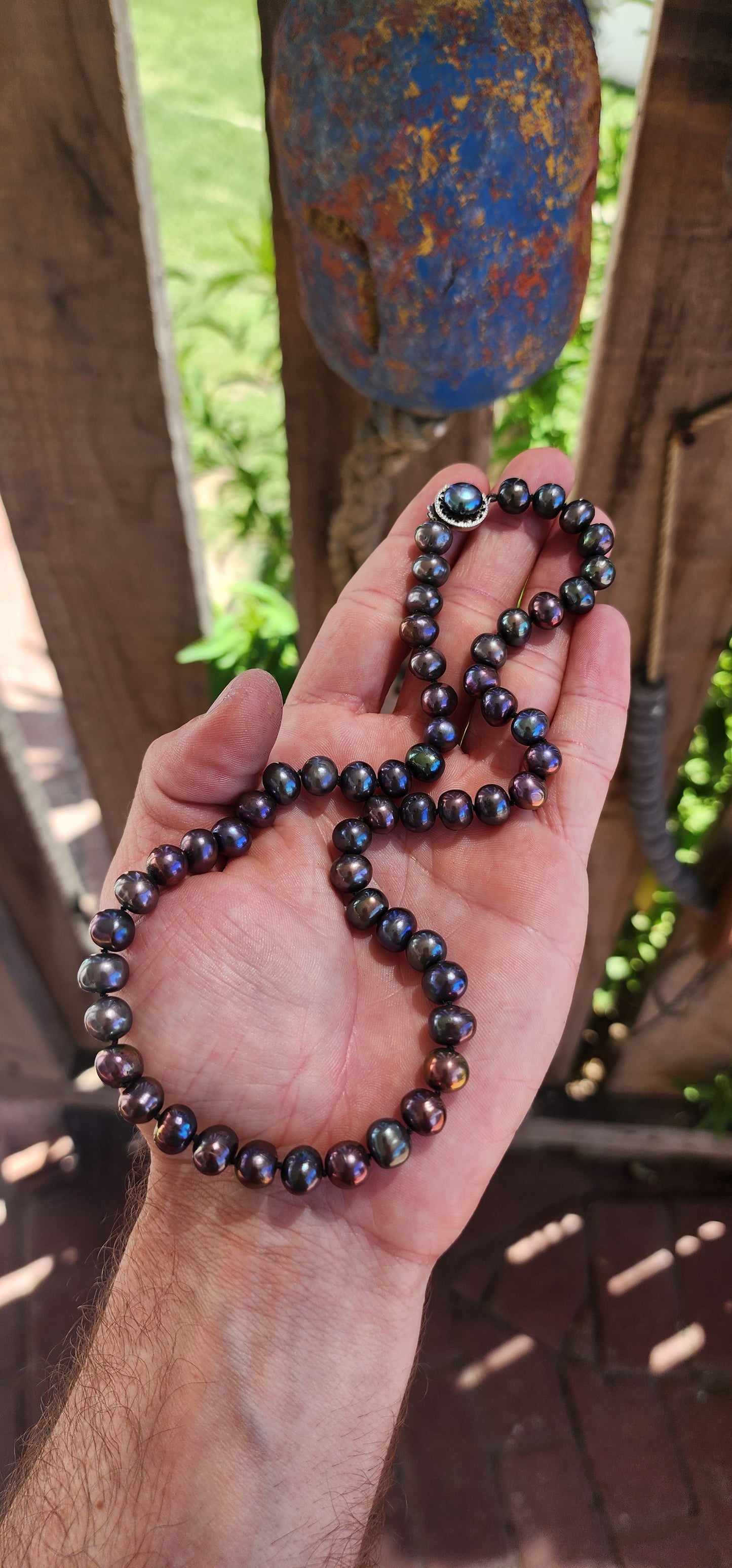 This exquisite necklace showcases the perfect harmony of nature’s beauty and artisanal craftsmanship. Composed of hand-selected freshwater black pearls, each pearl is a semi-round freeform shape, offering a unique and organic aesthetic.