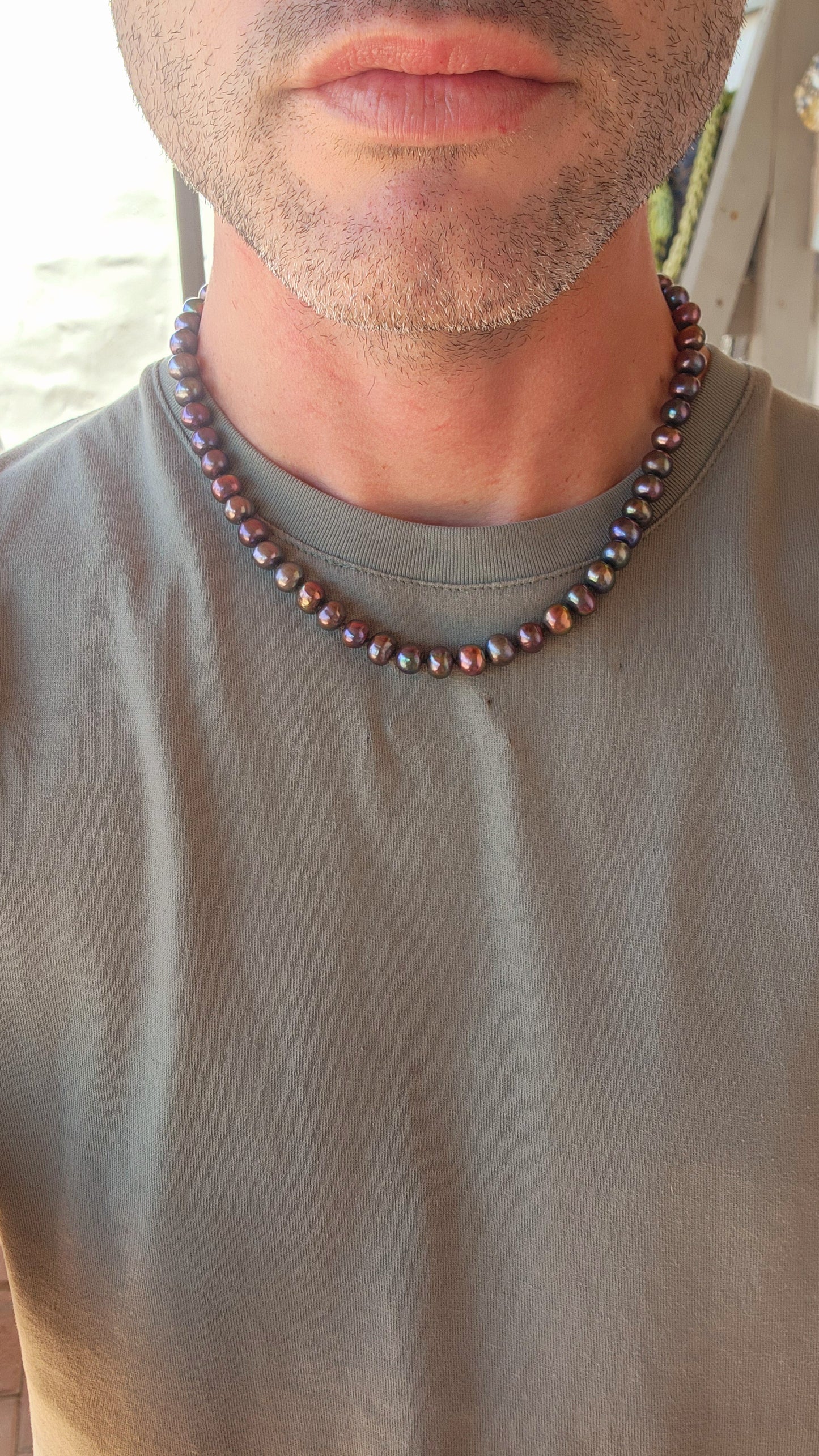 This exquisite necklace showcases the perfect harmony of nature’s beauty and artisanal craftsmanship. Composed of hand-selected freshwater black pearls, each pearl is a semi-round freeform shape, offering a unique and organic aesthetic.
