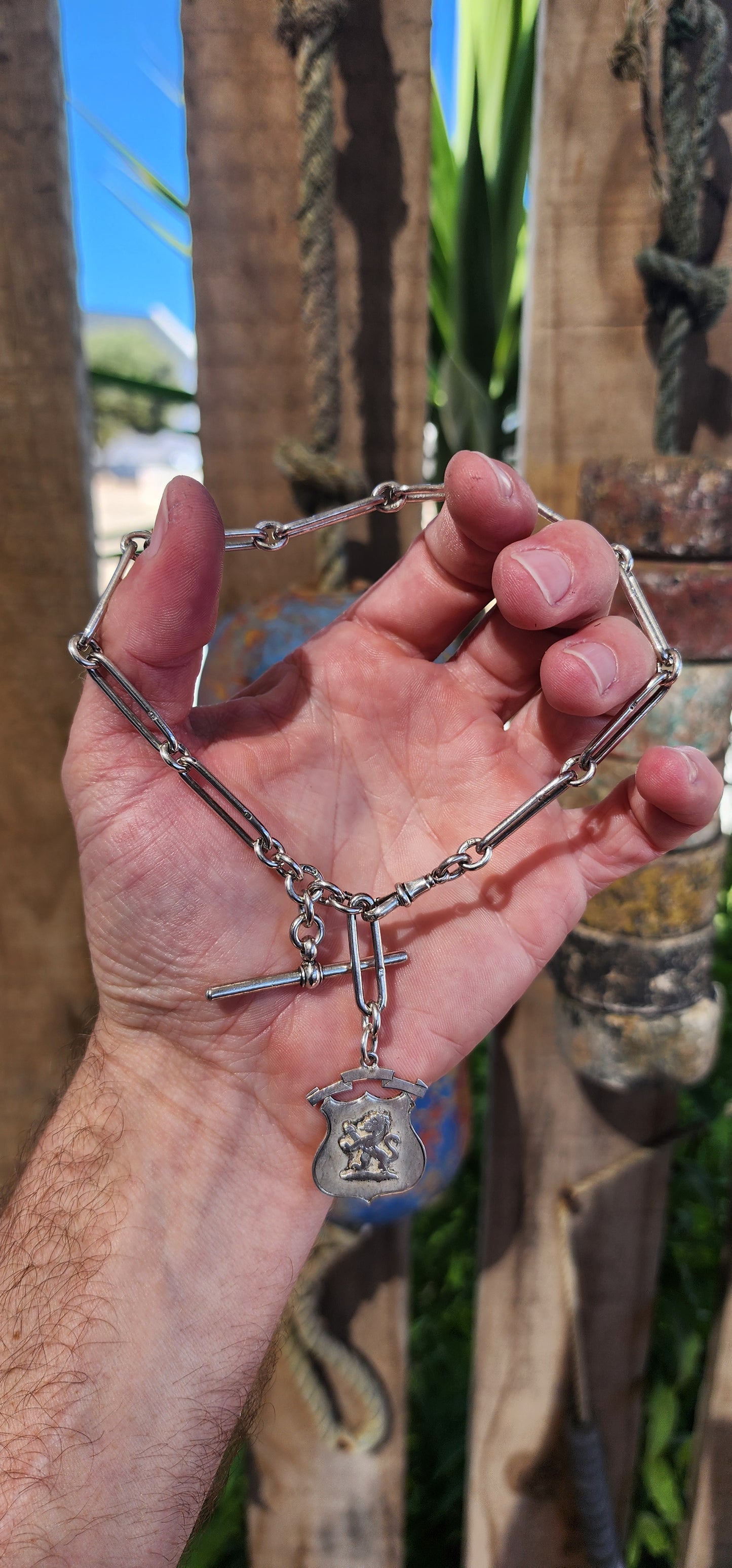 This exquisite sterling silver fob chain, crafted circa 1916 by the distinguished silversmith Joseph Moore of Birmingham, is a masterful representation of Edwardian elegance and functionality.