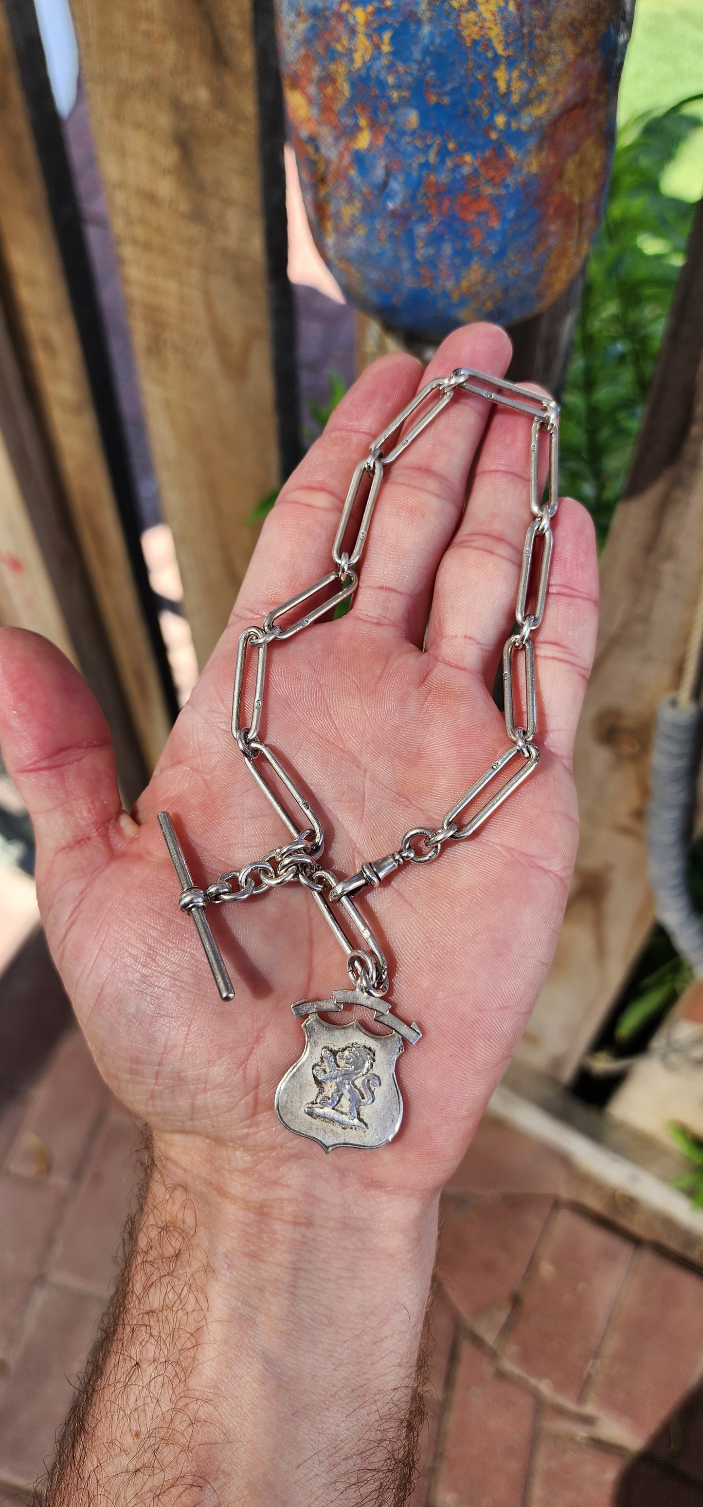 This exquisite sterling silver fob chain, crafted circa 1916 by the distinguished silversmith Joseph Moore of Birmingham, is a masterful representation of Edwardian elegance and functionality.