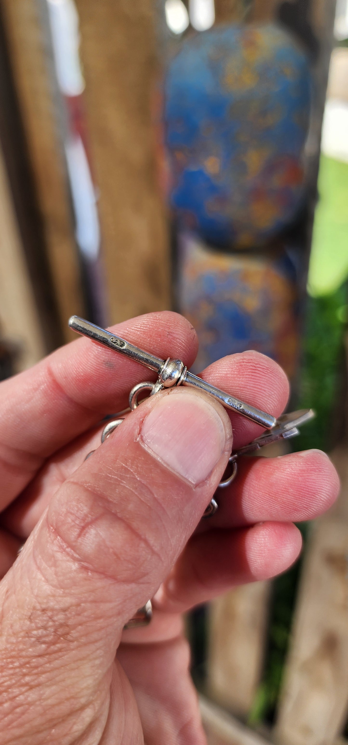 This exquisite sterling silver fob chain, crafted circa 1916 by the distinguished silversmith Joseph Moore of Birmingham, is a masterful representation of Edwardian elegance and functionality.