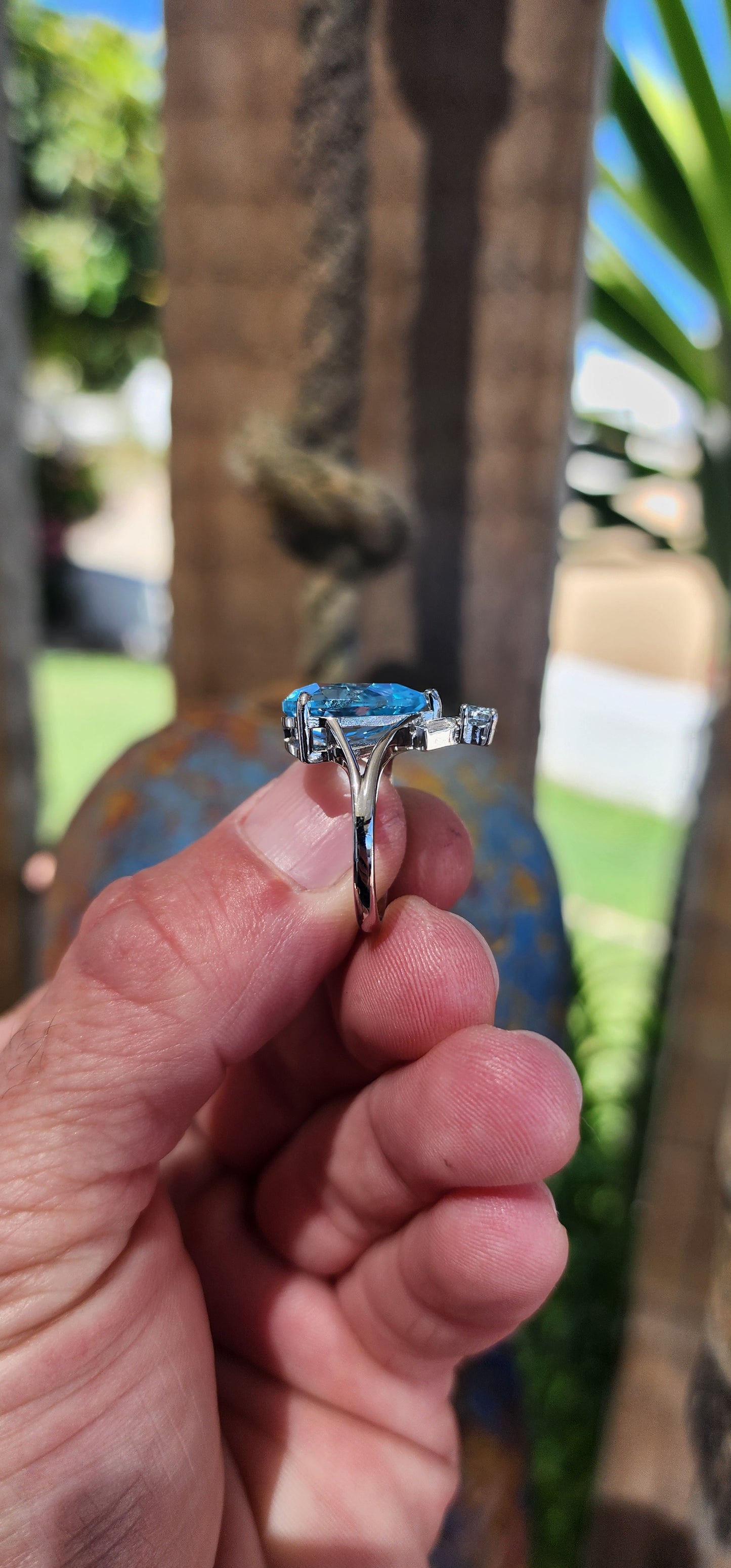 This Art Deco-inspired sterling silver ring is an absolute showstopper! At its heart lies a stunning, pear-cut Swiss blue topaz that radiates an ocean-like brilliance, its generous size drawing all eyes to its dazzling hue.