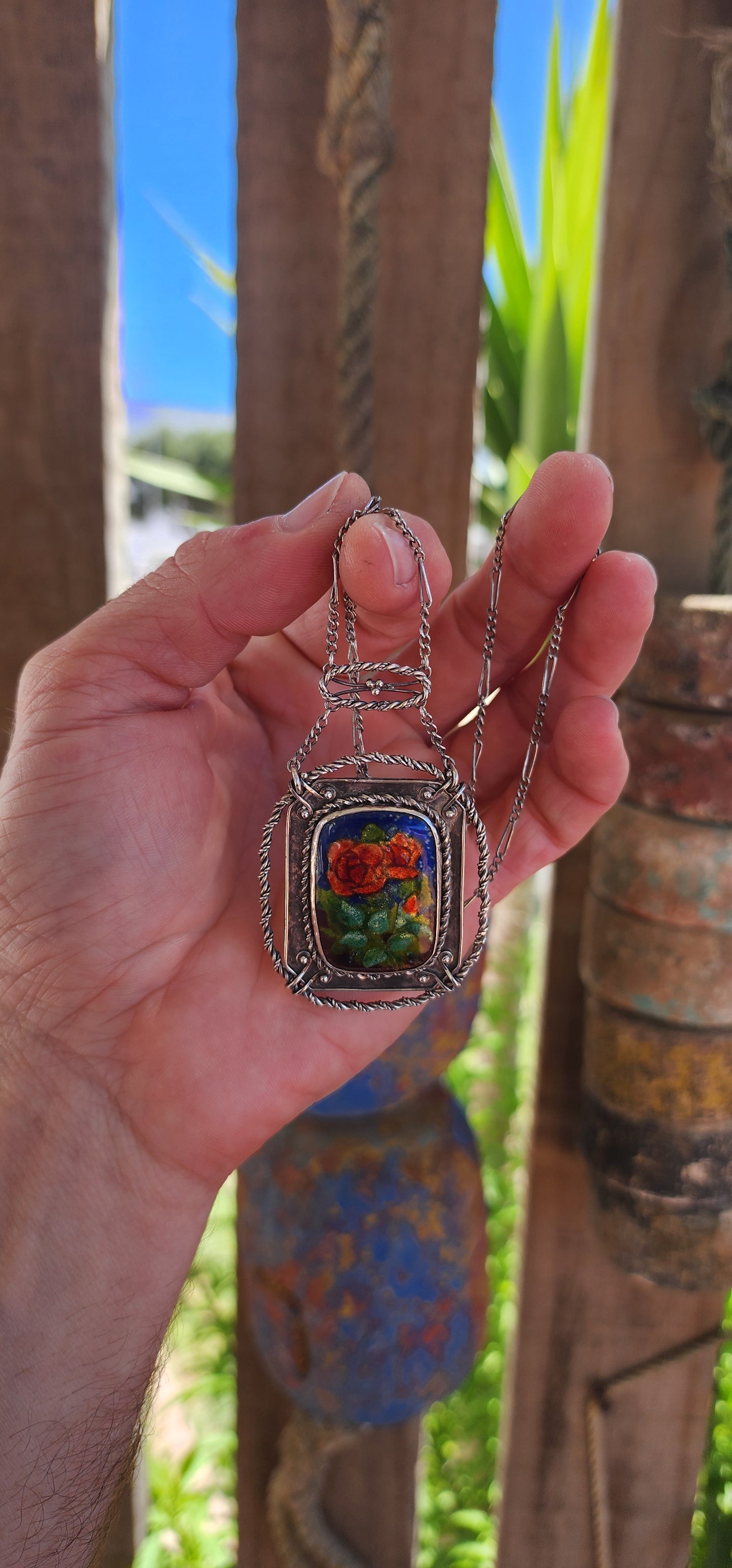 This antique sterling silver and enamel necklace is a striking example of the Arts and Crafts Movement, a design era (c. 1880–1920) that championed handcrafted, nature-inspired jewelry as a response to the mass production of the Industrial Revolution.