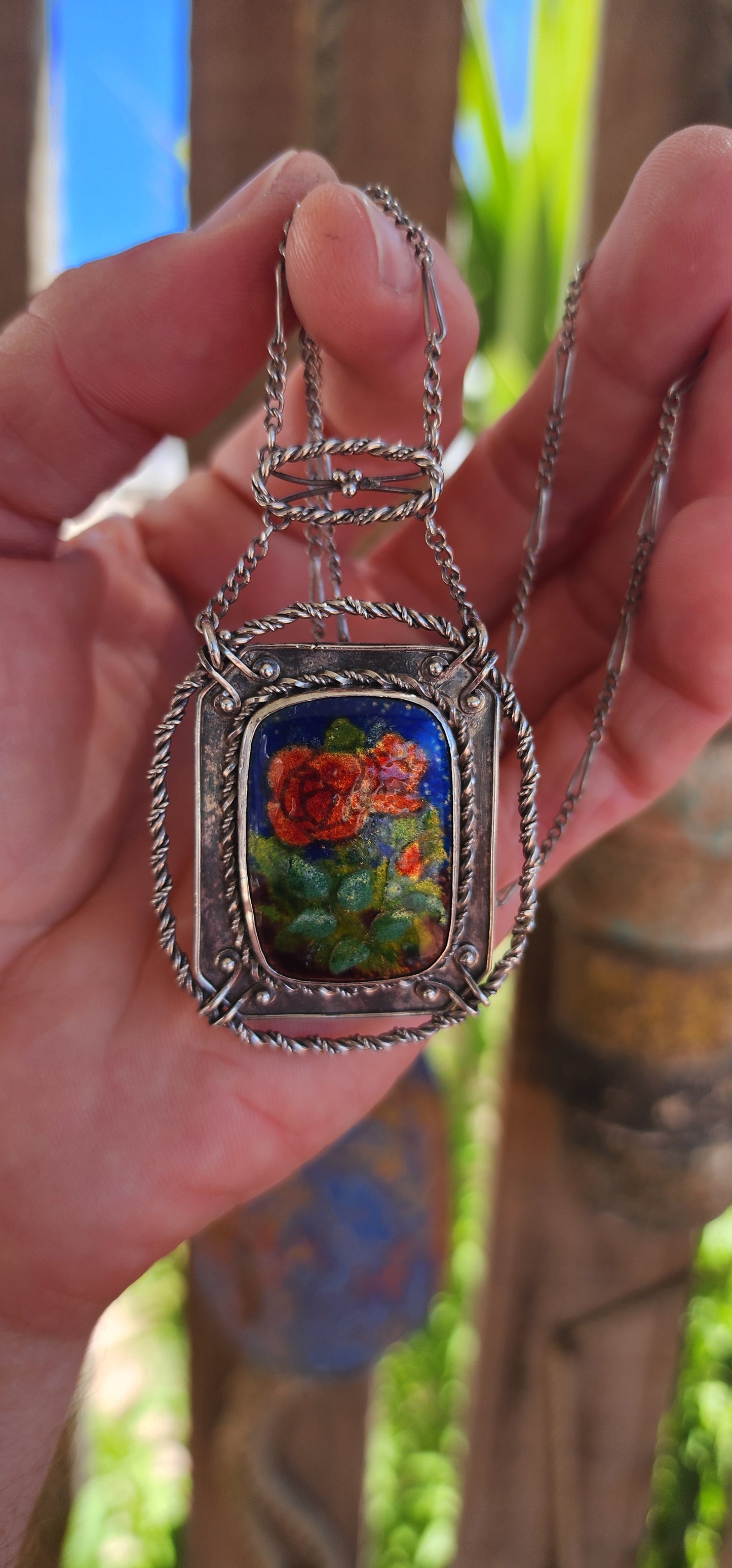 This antique sterling silver and enamel necklace is a striking example of the Arts and Crafts Movement, a design era (c. 1880–1920) that championed handcrafted, nature-inspired jewelry as a response to the mass production of the Industrial Revolution.