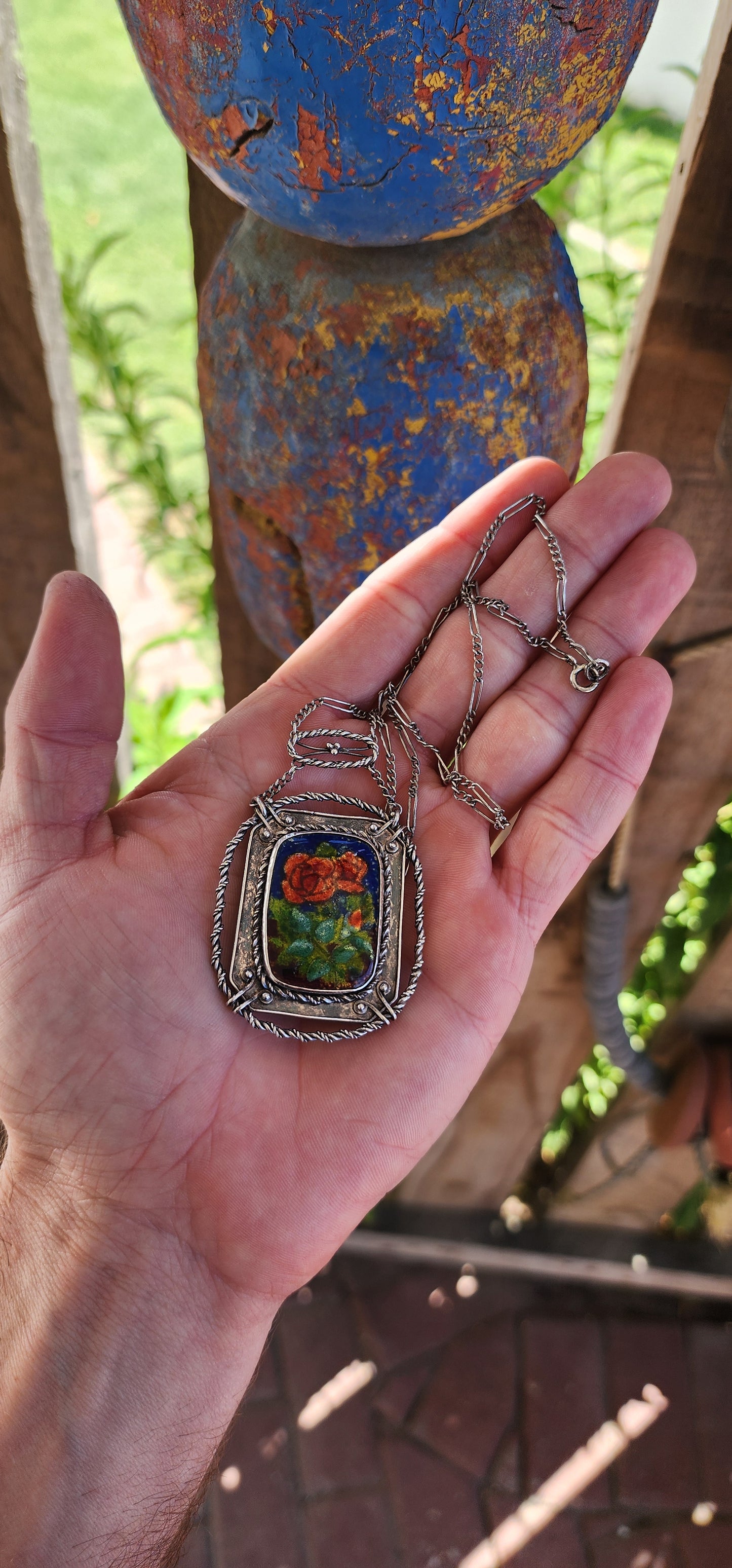 This antique sterling silver and enamel necklace is a striking example of the Arts and Crafts Movement, a design era (c. 1880–1920) that championed handcrafted, nature-inspired jewelry as a response to the mass production of the Industrial Revolution.