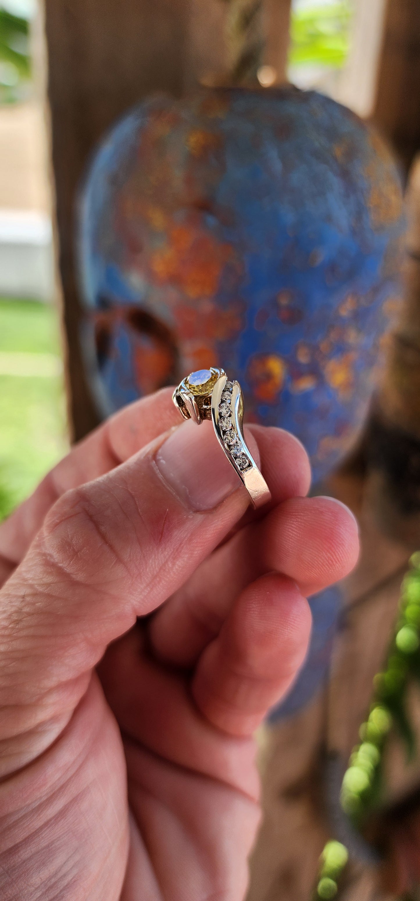This breathtaking handmade sterling silver ring is a true work of art, seamlessly blending contemporary elegance with timeless beauty. The fluid, sculptural crossover design of the band exudes modernity while maintaining an air of classic refinement.