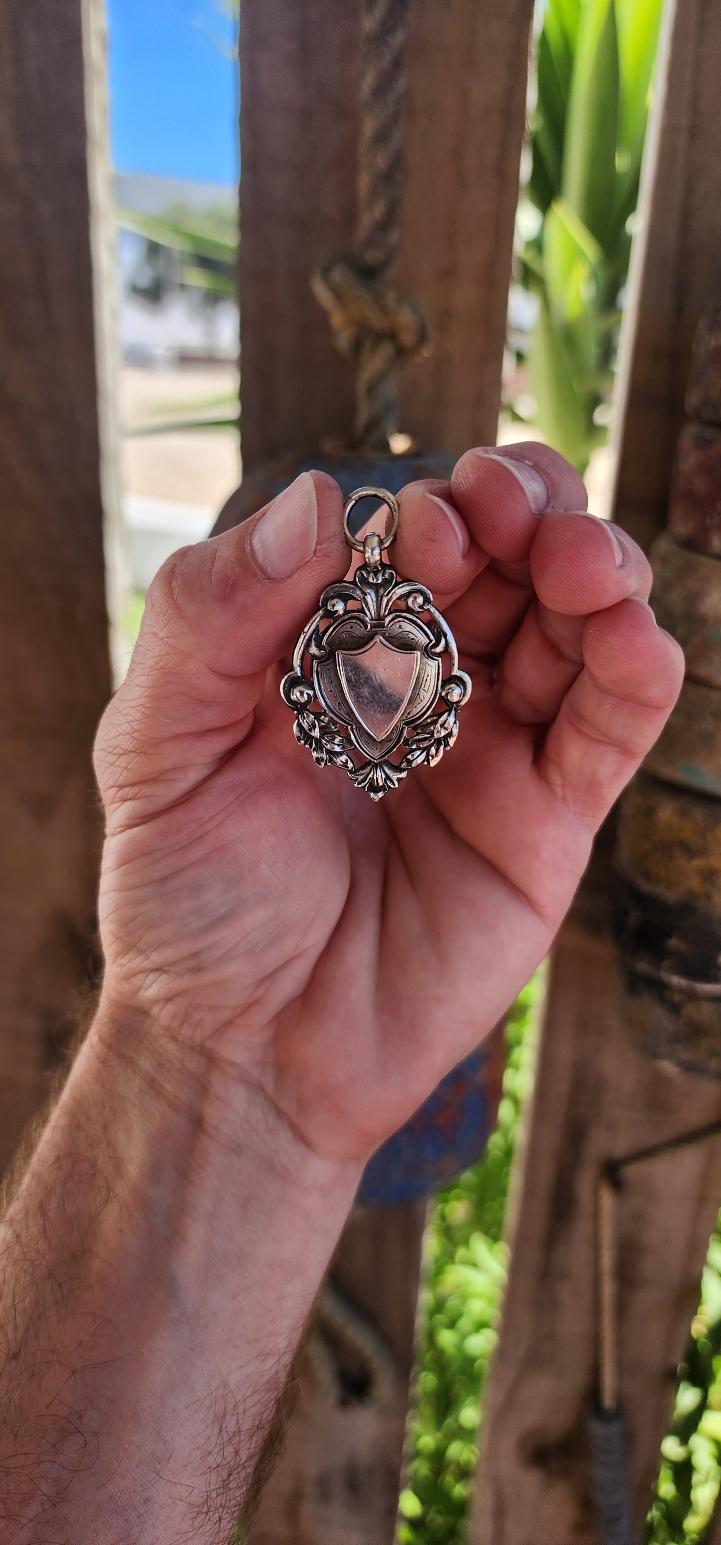 This exquisite and highly detailed hallmarked sterling silver fob pendant, crafted by the renowned silversmith William James Dingley, is an outstanding example of early 20th-century British silverwork.