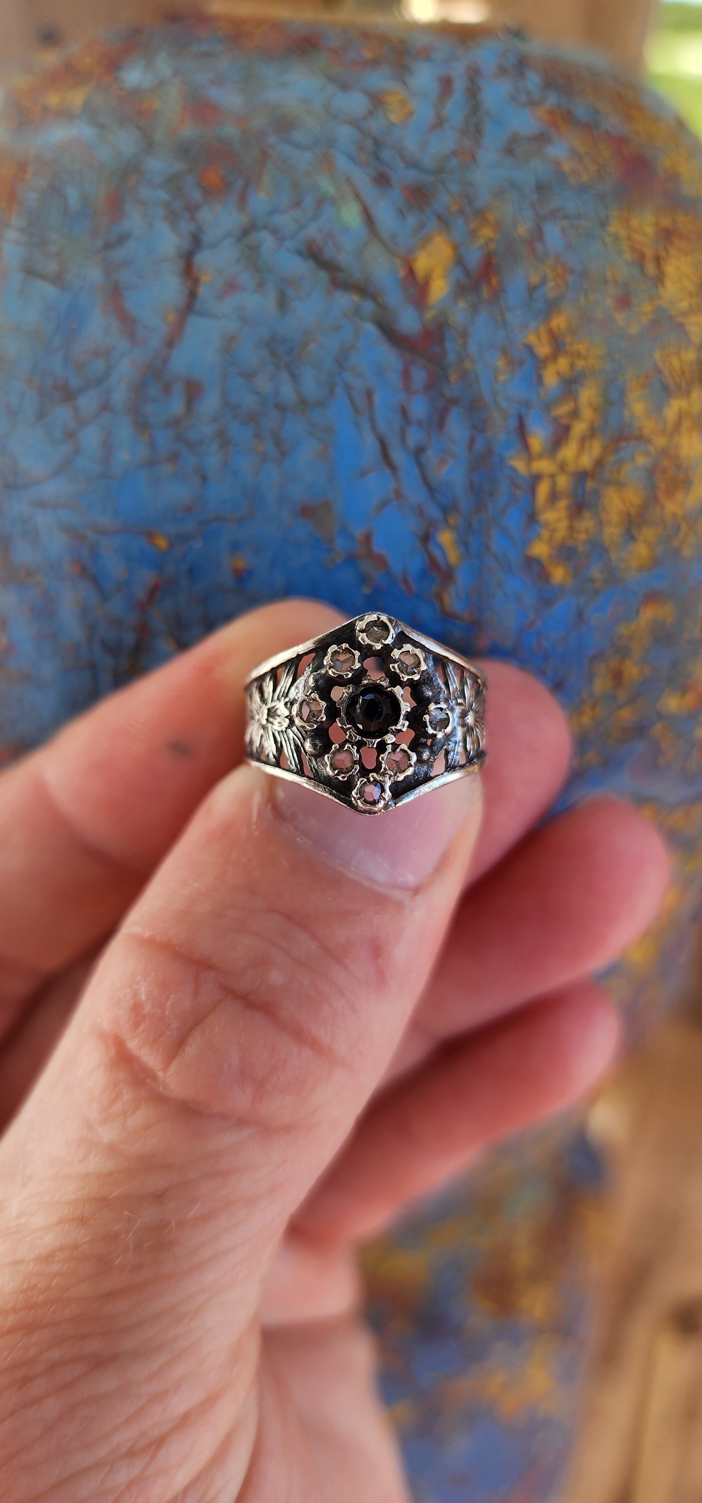 This vintage sterling silver ring is a striking piece with Victorian Gothic influences, showcasing intricate craftsmanship and elegant detailing.