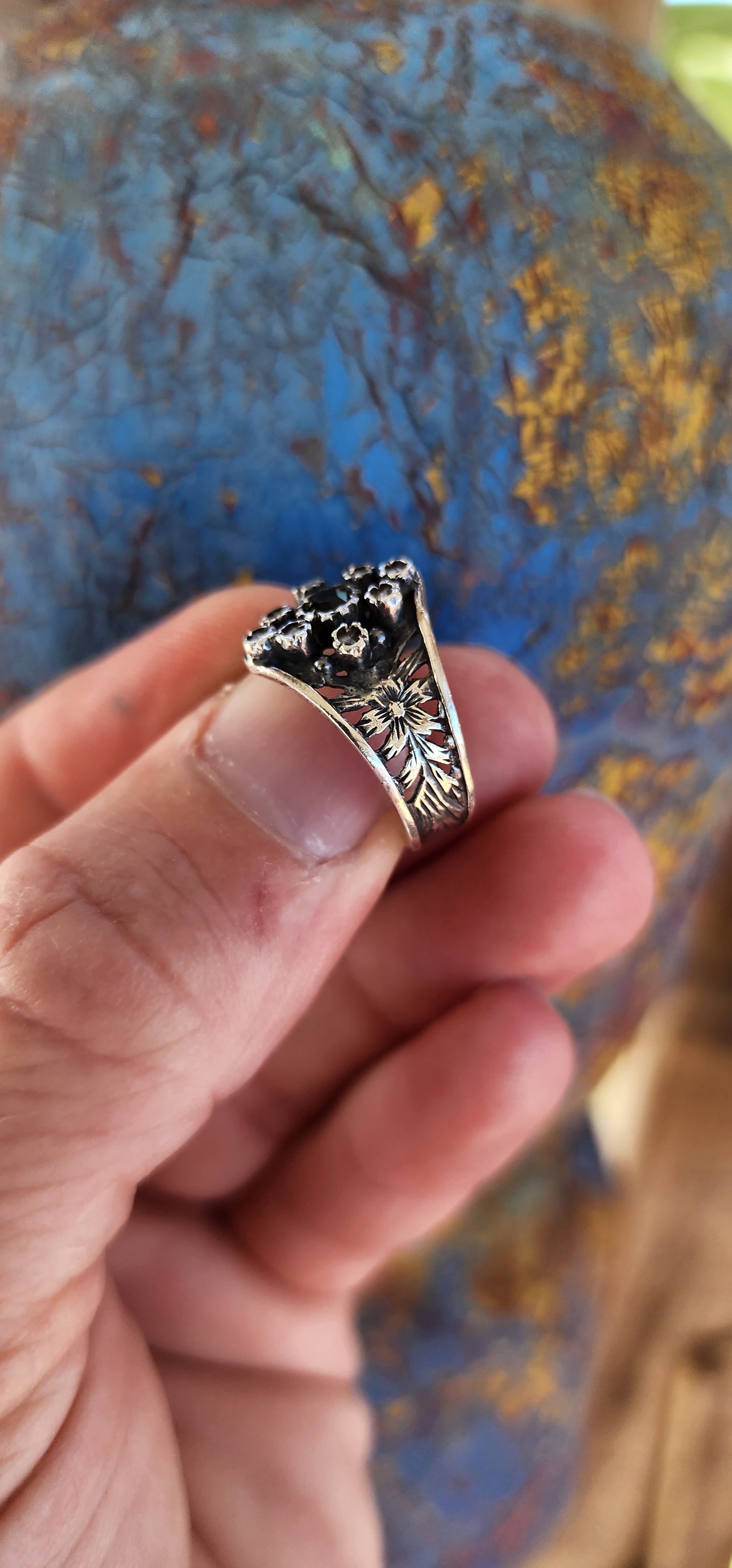 This vintage sterling silver ring is a striking piece with Victorian Gothic influences, showcasing intricate craftsmanship and elegant detailing.