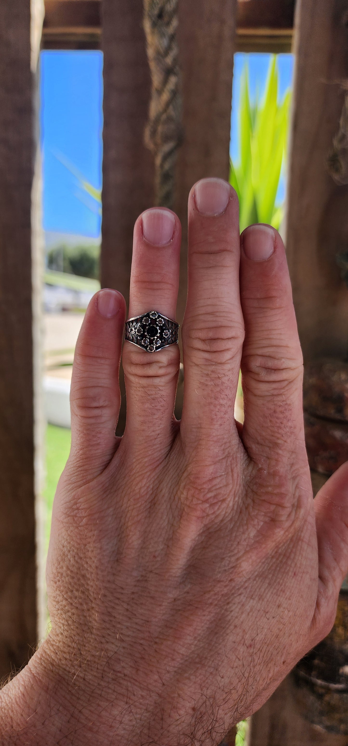 This vintage sterling silver ring is a striking piece with Victorian Gothic influences, showcasing intricate craftsmanship and elegant detailing.