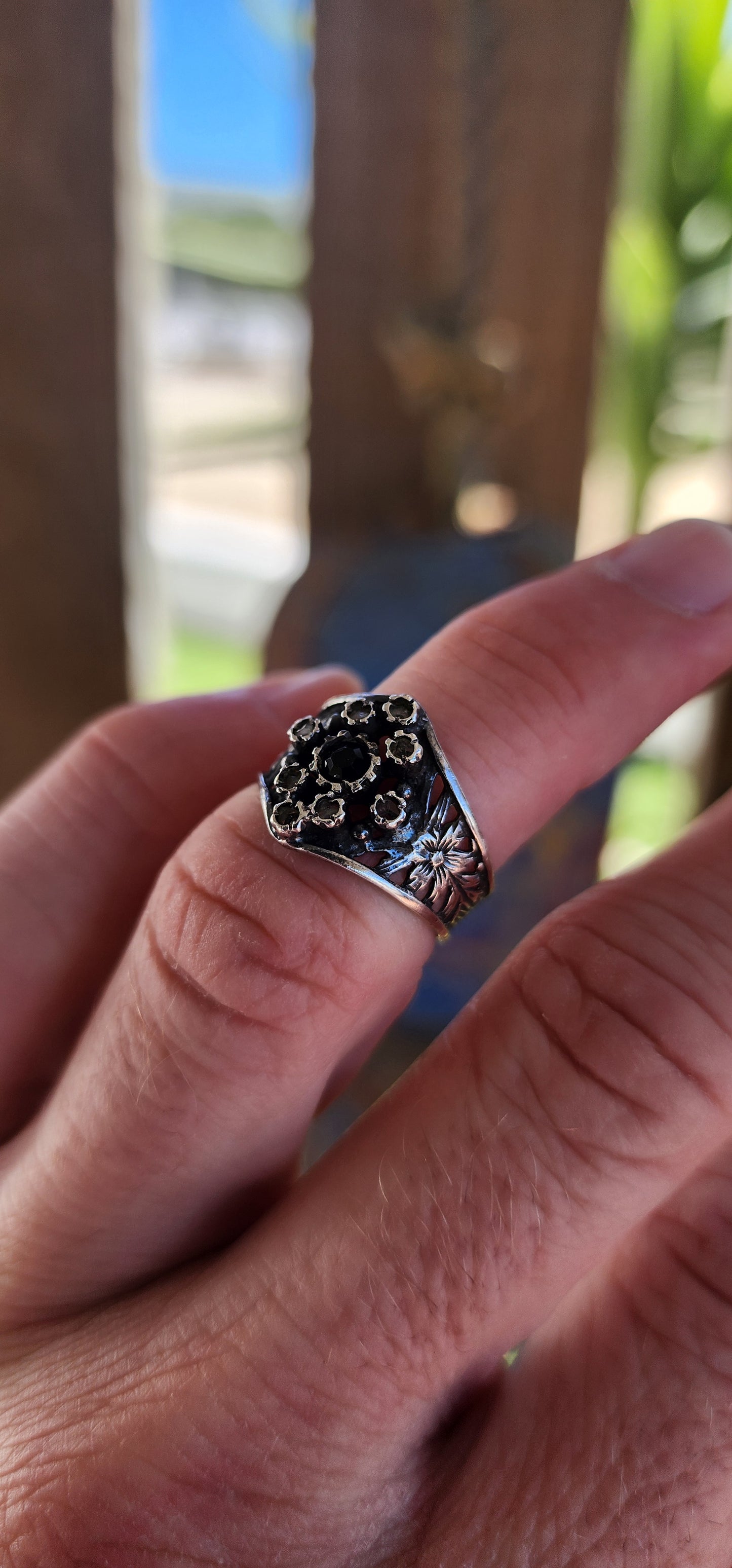 This vintage sterling silver ring is a striking piece with Victorian Gothic influences, showcasing intricate craftsmanship and elegant detailing.