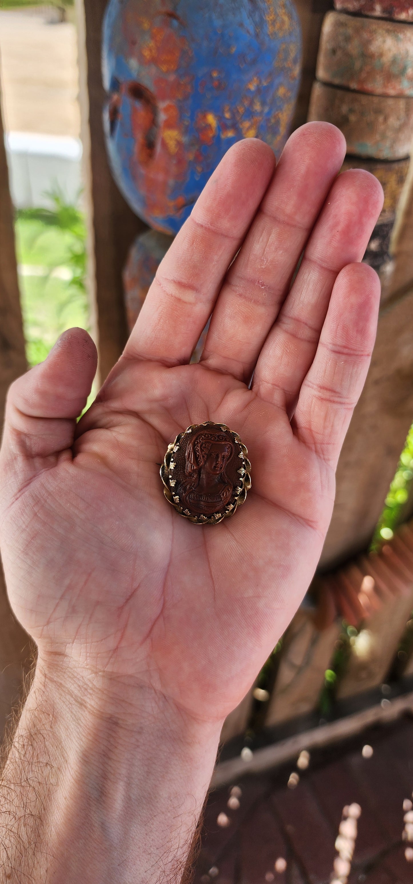 This exquisite antique late 18th-century brooch is a finely crafted example of Georgian-era jewelry, featuring a high-relief glass cameo depicting a noblewoman in period attire.