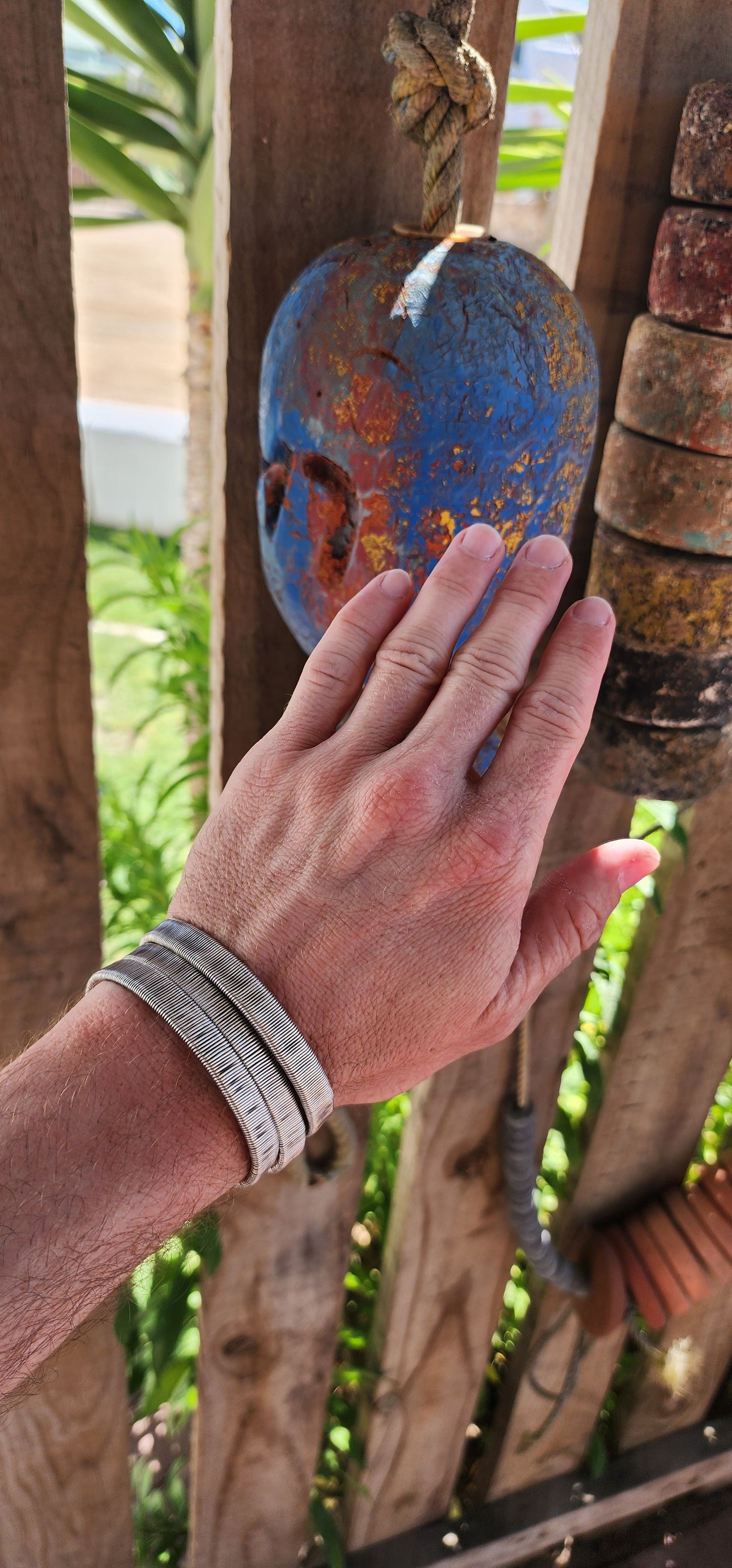 These bangles are a lot of three vintage Karen Hill Tribe open cuff bangles, crafted from solid 999 silver. Their weighty and solid nature, along with the intricate wrapped wire design, makes them unique pieces with both aesthetic and cultural value.